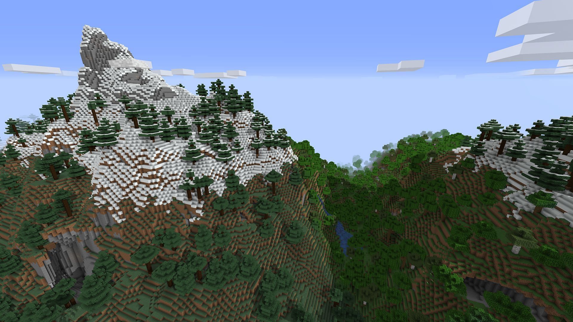 A mountain and wooded ravine found near spawn (Image via Minecraft)
