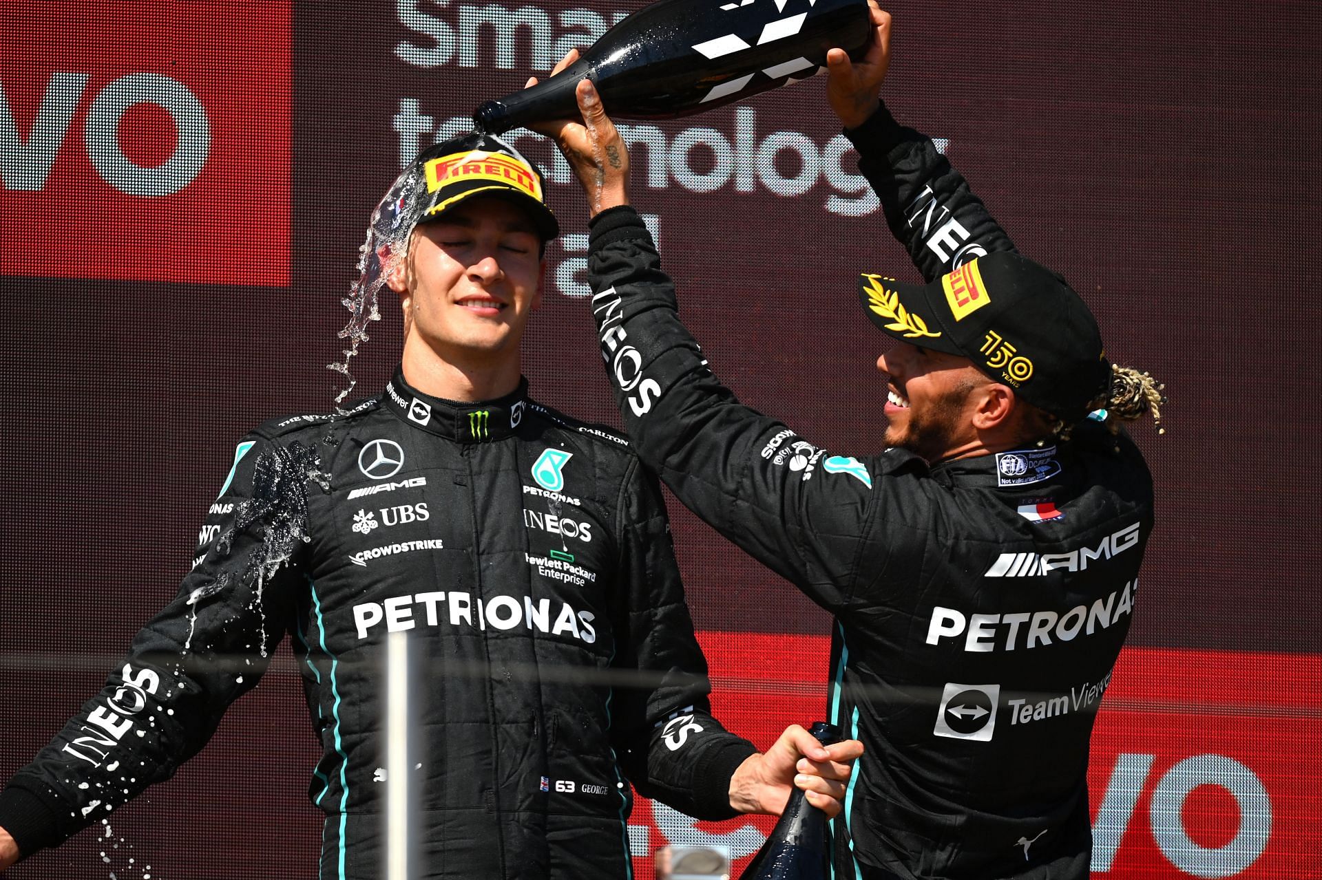 Mercedes drivers George Russell (left) and Lewis Hamilton (right) celebrate on the podium at the 2022 F1 French GP (Photo by Dan Mullan/Getty Images)