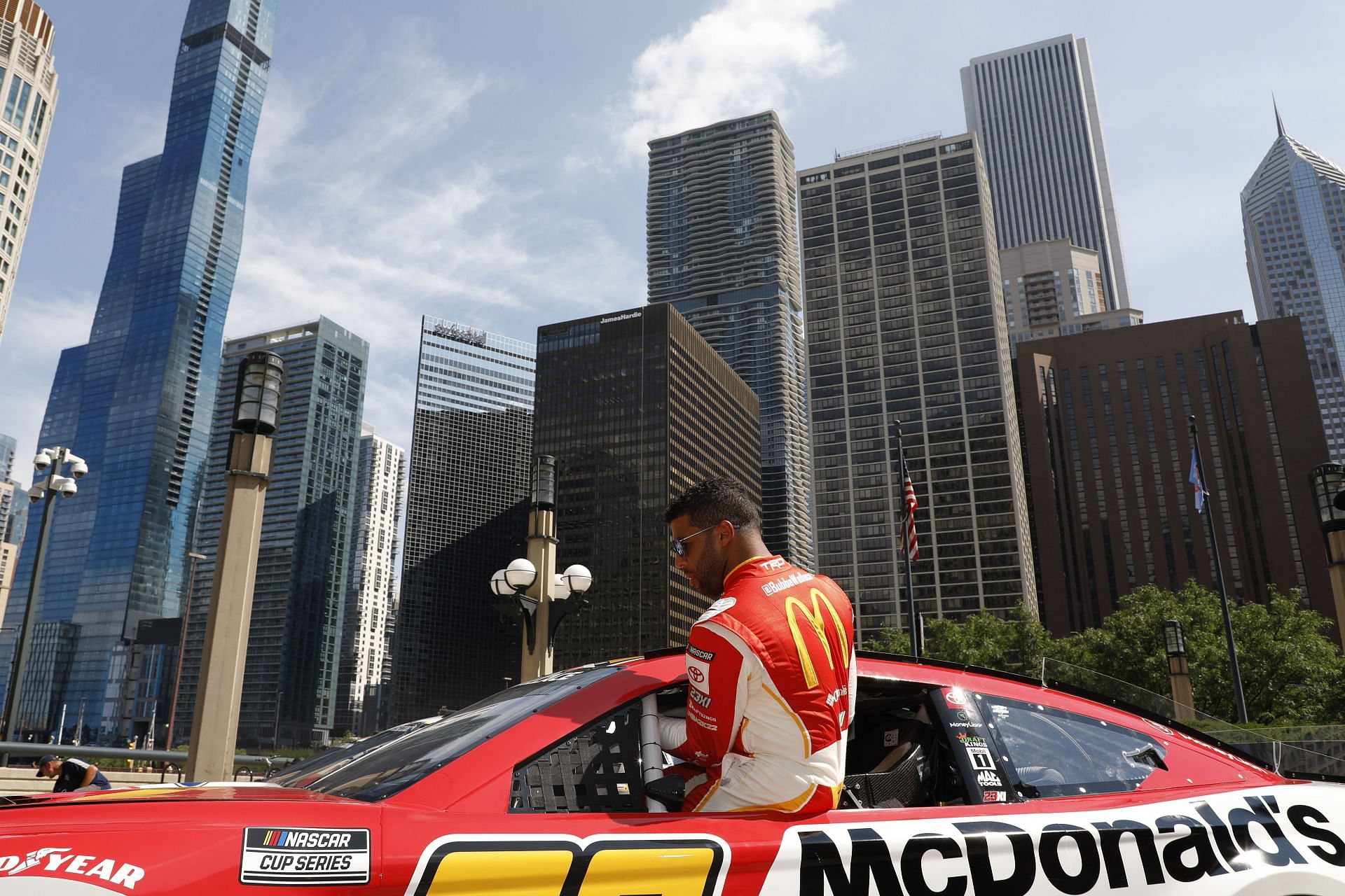 Bubba Wallace Jr. gets into his car before driving around downtown Chicago in promotion of the 2023 NASCAR Chicago Street Race announcement in Chicago, Illinois (Photo by Patrick McDermott/Getty Images)