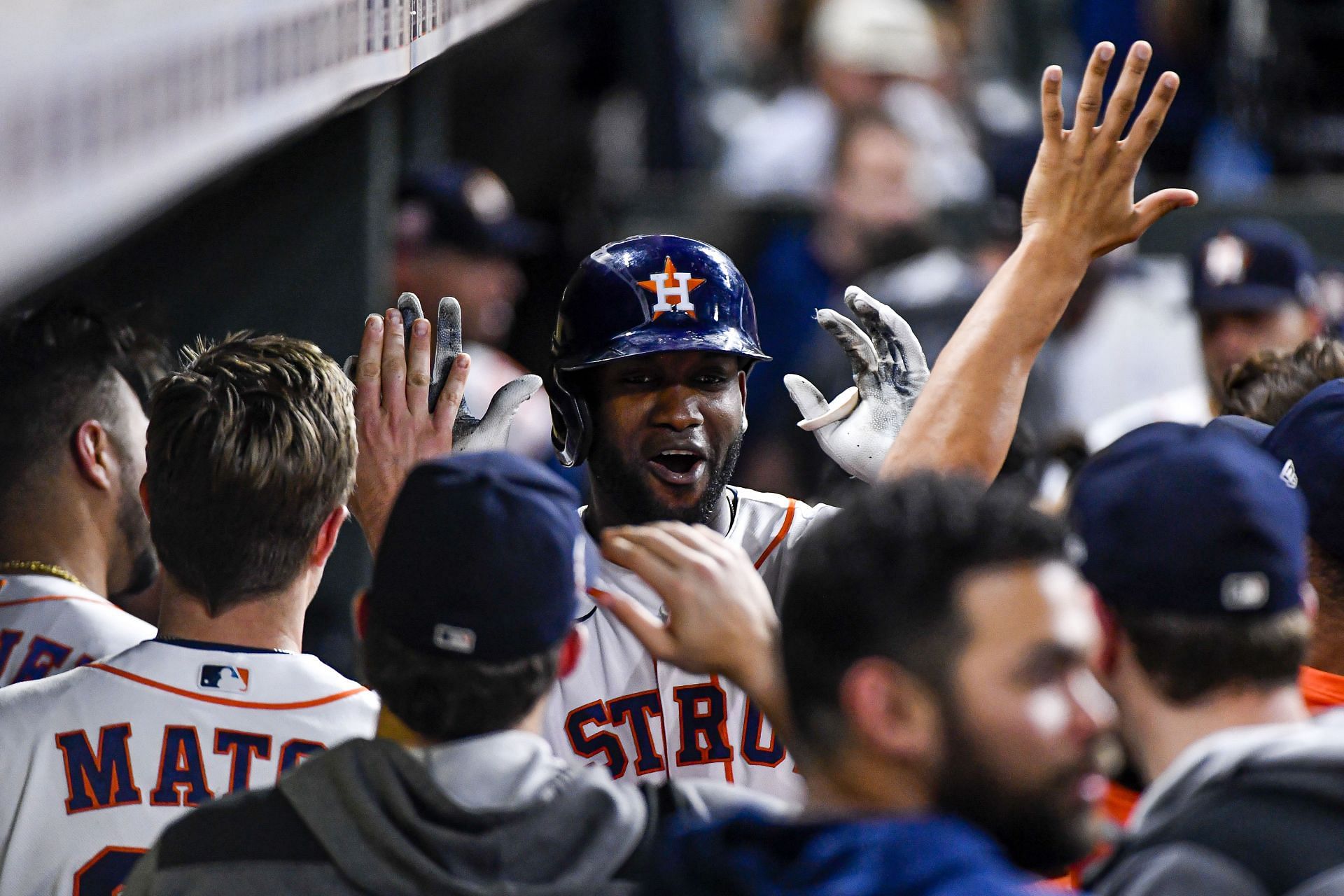 Yordan Alvarez of the Houston Astros celebrates in the dugout after hitting a solo home run.