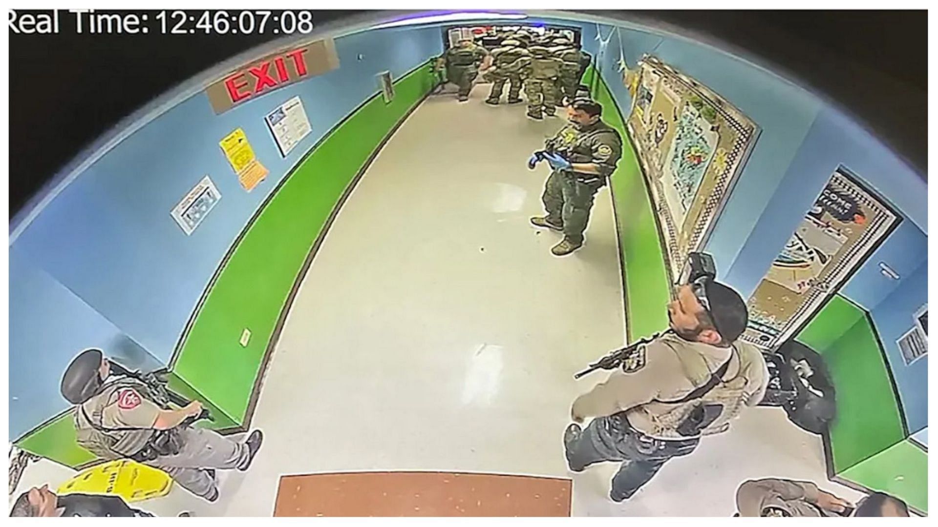 Authorities are seen waiting in the hallway instead of directly engaging with the shooter (image via Robb elementary school)