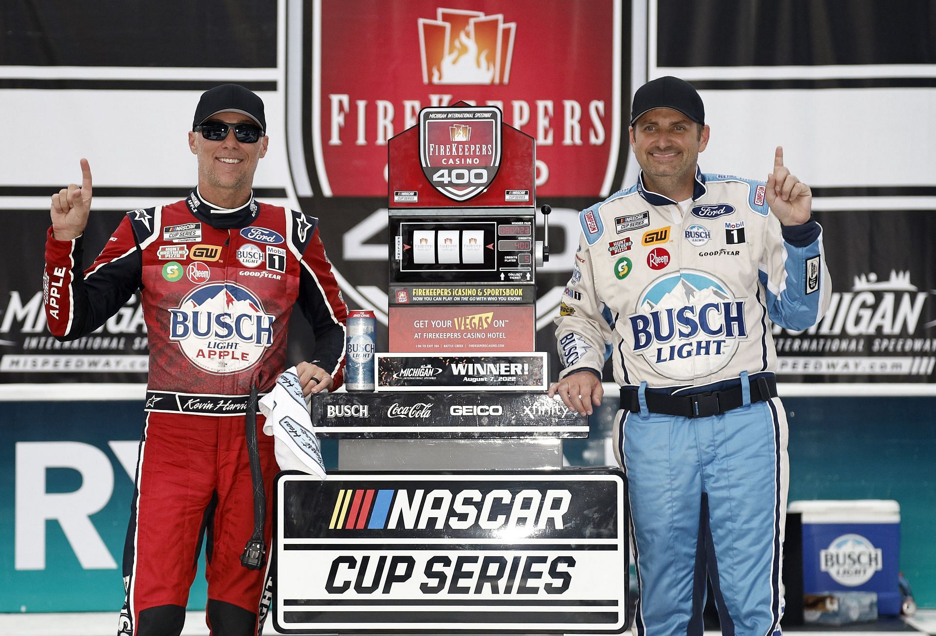 Kevin Harvick (left) and crew chief Rodney Childers celebrate in victory lane after winning the NASCAR Cup Series FireKeepers Casino 400 at Michigan International Speedway