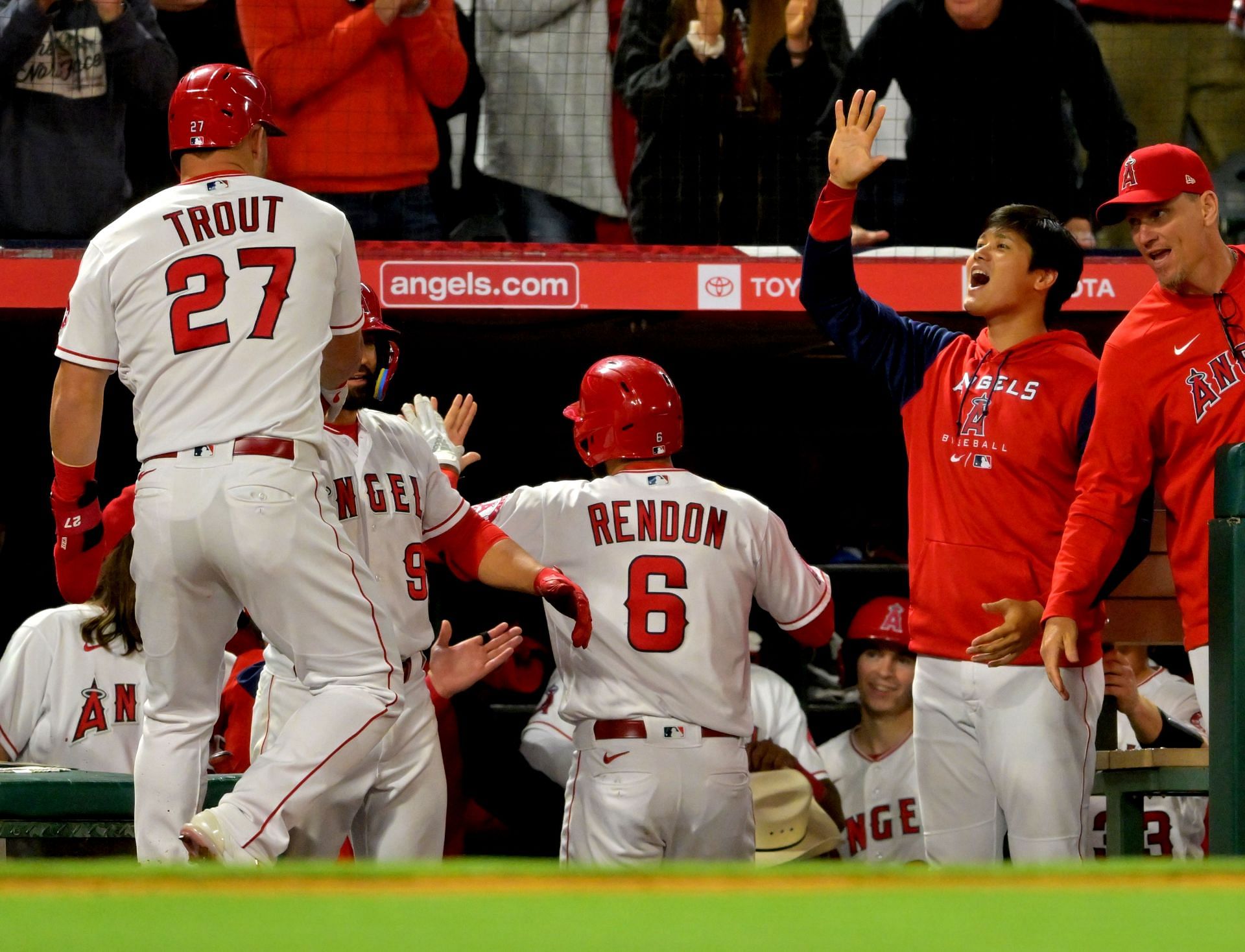 Trout and Rendon are greeted by Ohtani in the dugout