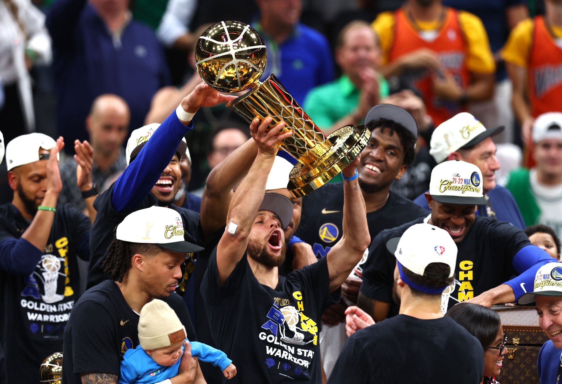 Steph Curry hold the Larry O&#039;Brien trophy at the 2022 NBA Finals.