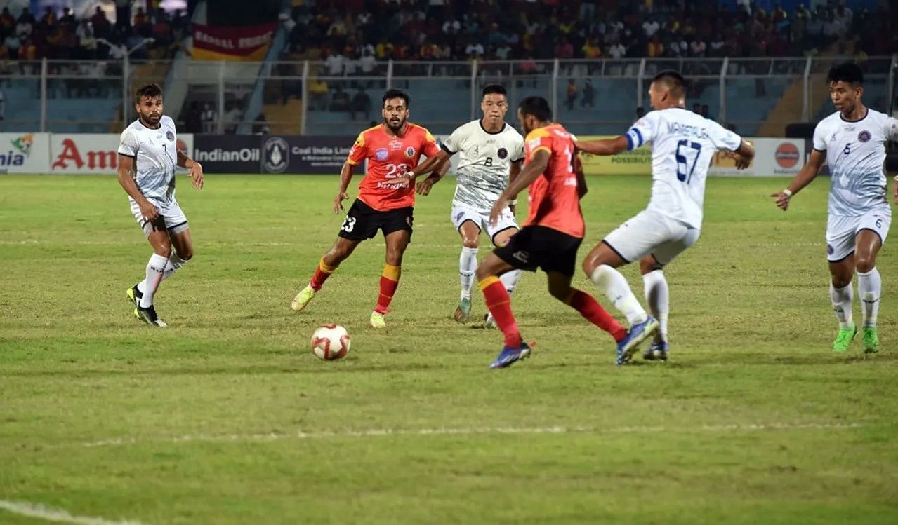 Emami East Bengal and Rajasthan United FC players tussling for the ball.