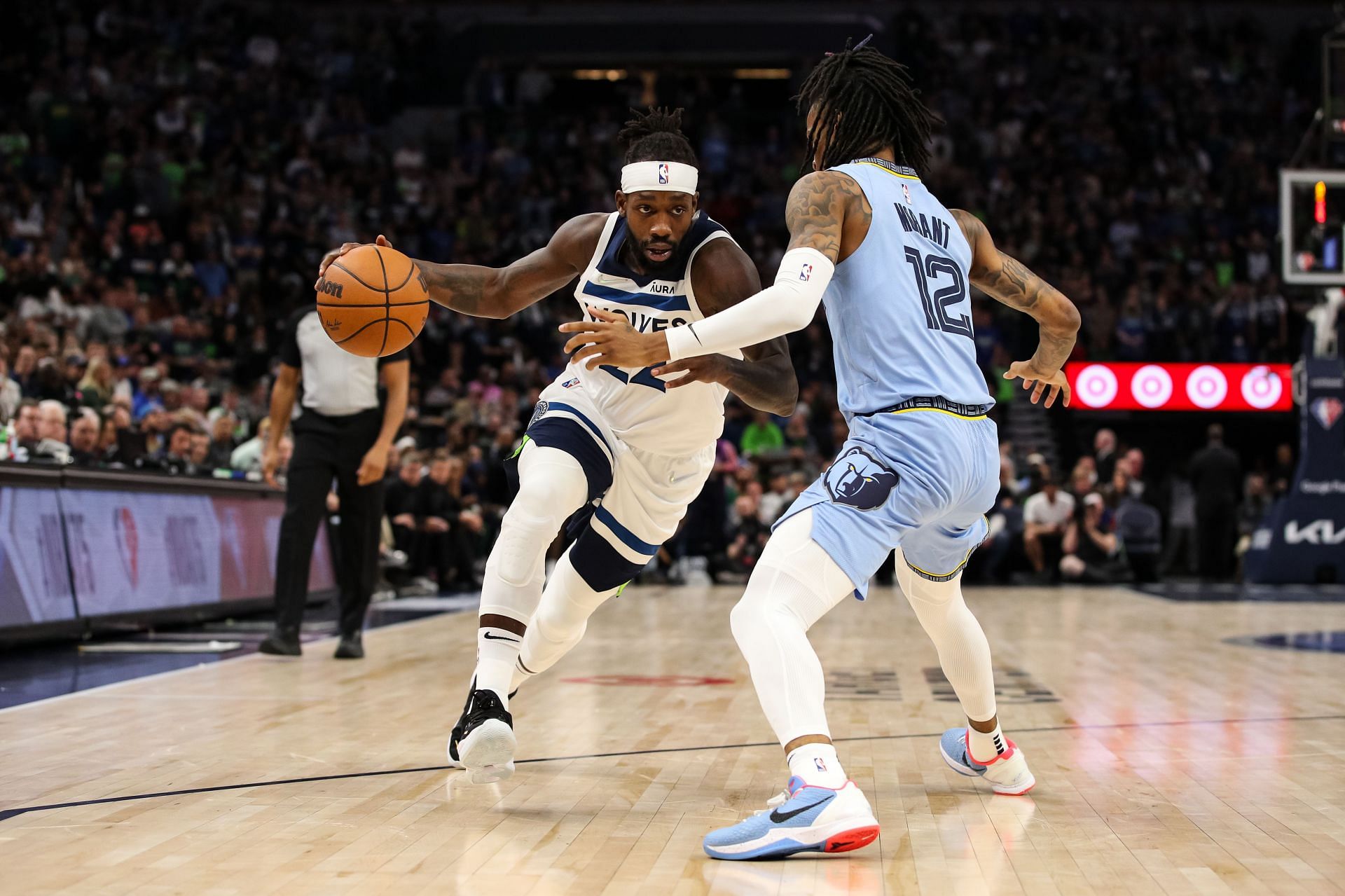 Patrick Beverley drives to the basket while Ja Morant defends