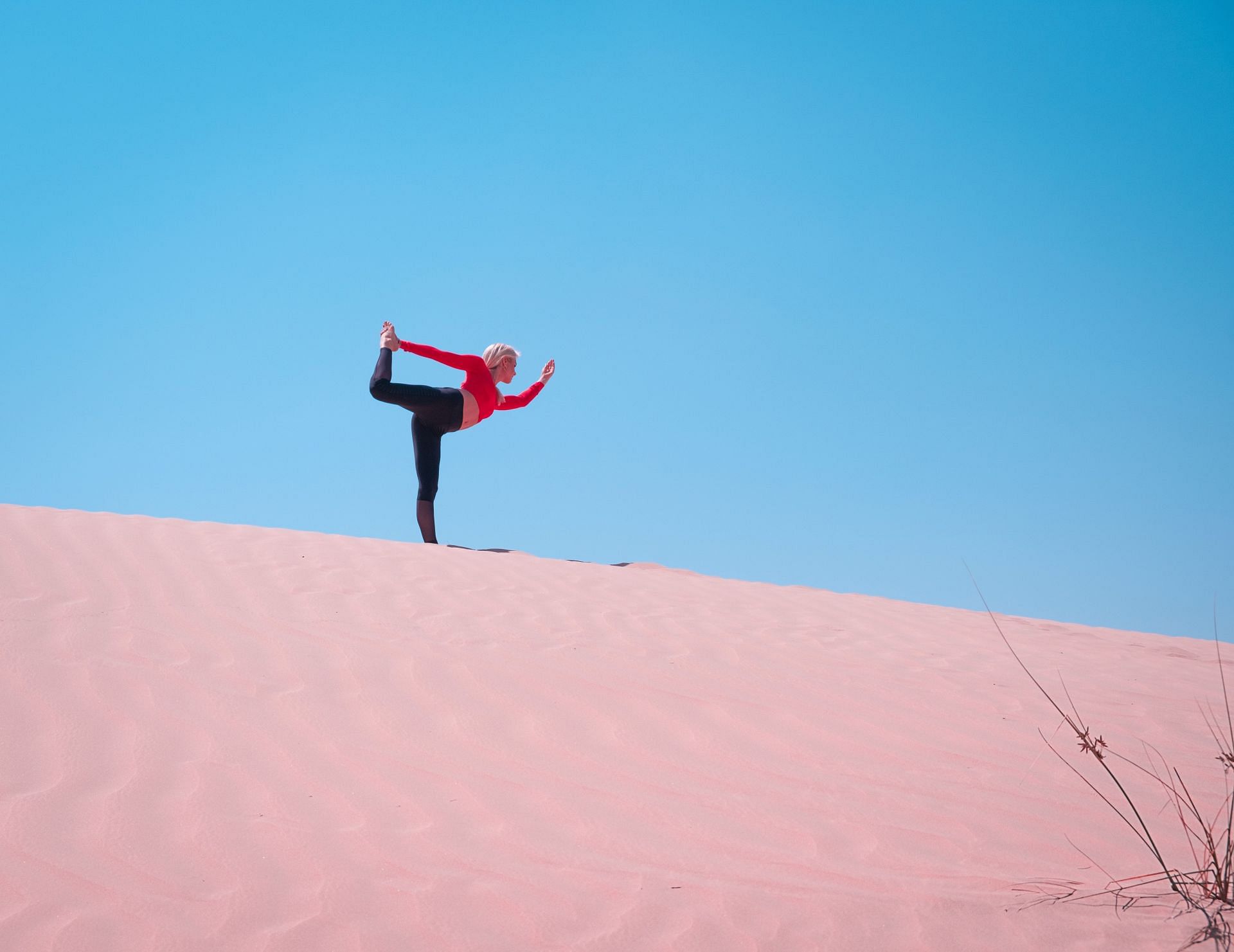 Yoga stretches can help runners enhance and improve their flexibility. (Image via Pexels/The Lazy Artist Gallery)