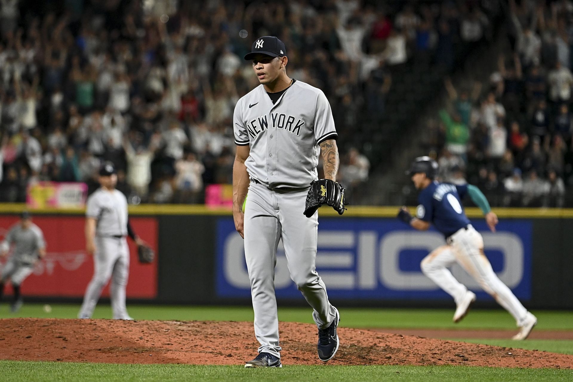 New York Yankees pitcher Jonathan Loaisiga walks off the mound following a walk-off victory by the Seattle Mariners.