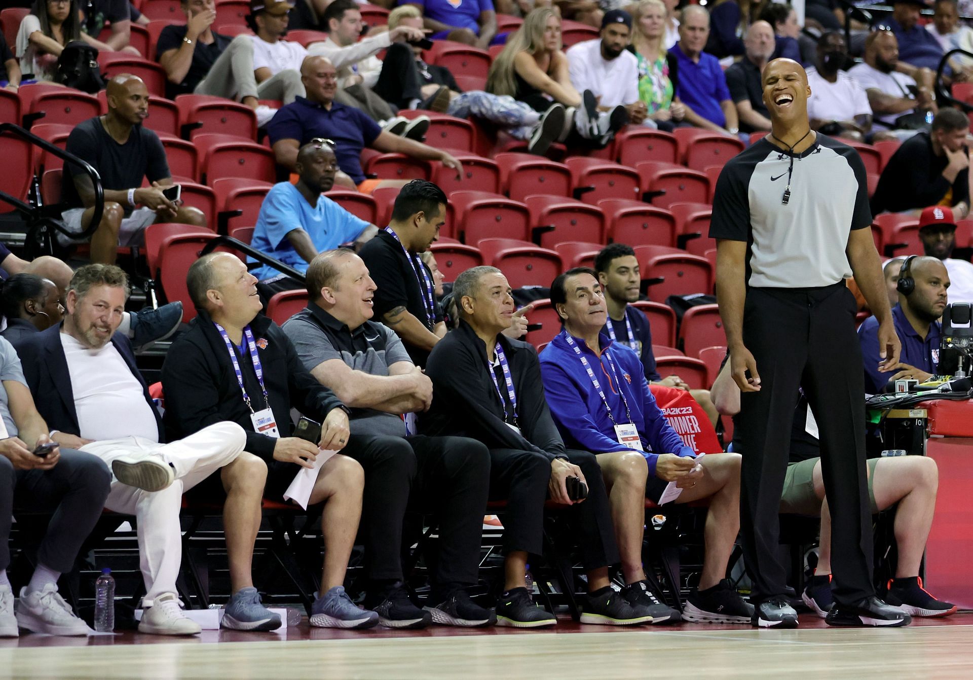 ESPN sports analyst and former NBA player Richard Jefferson (R) laughs as people in the front row, including owner James Dolan (L) and head coach Tom Thibodeau (3rd L) of the New York Knicks, talk to him as he officiates the second quarter of a game between the Knicks and the Portland Trail Blazers during the 2022 NBA Summer League at the Thomas &amp; Mack Center on July 11, 2022 in Las Vegas, Nevada.