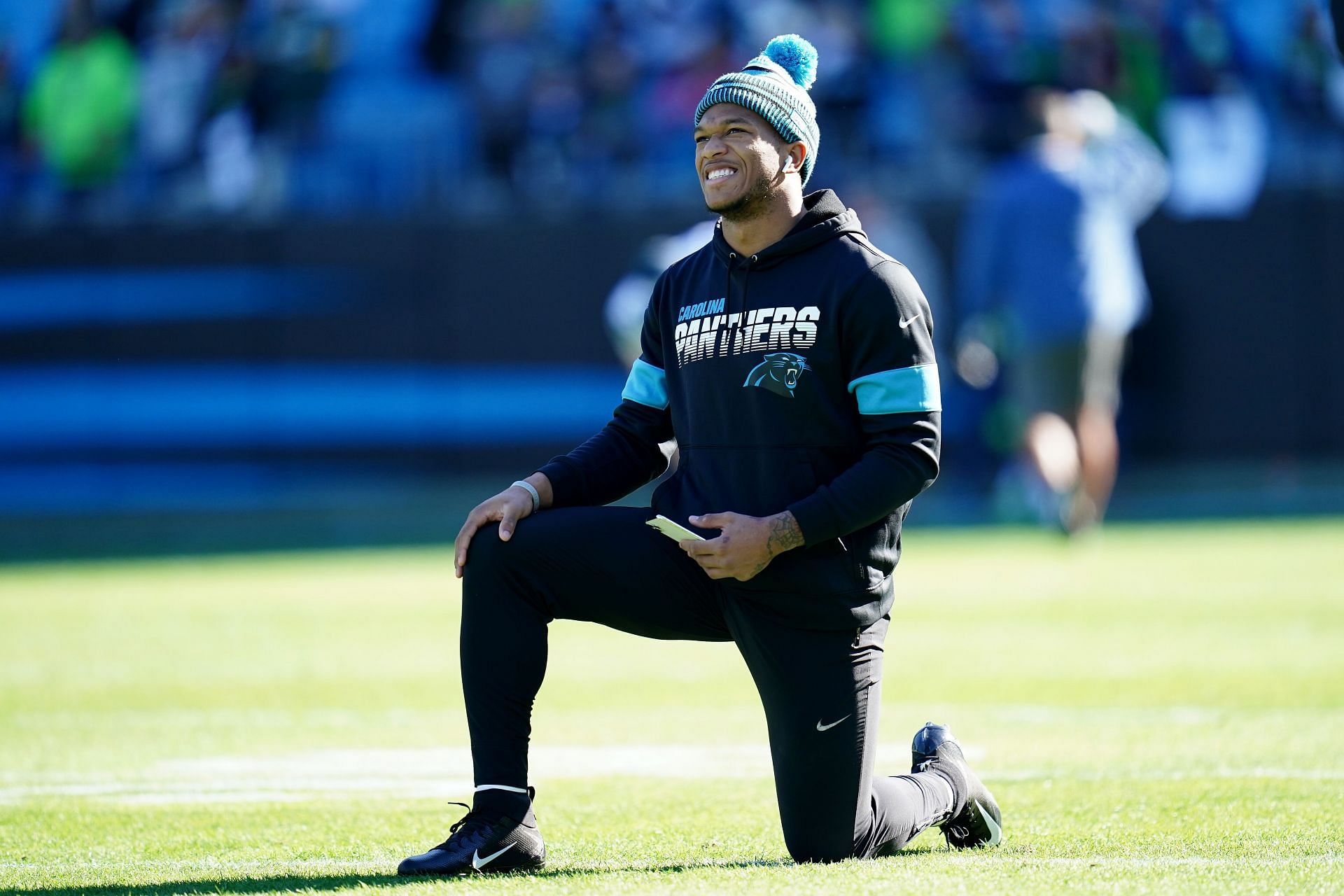 Carolina Panthers wide receiver DJ Moore leaps into the stands to break up  a fight between fans