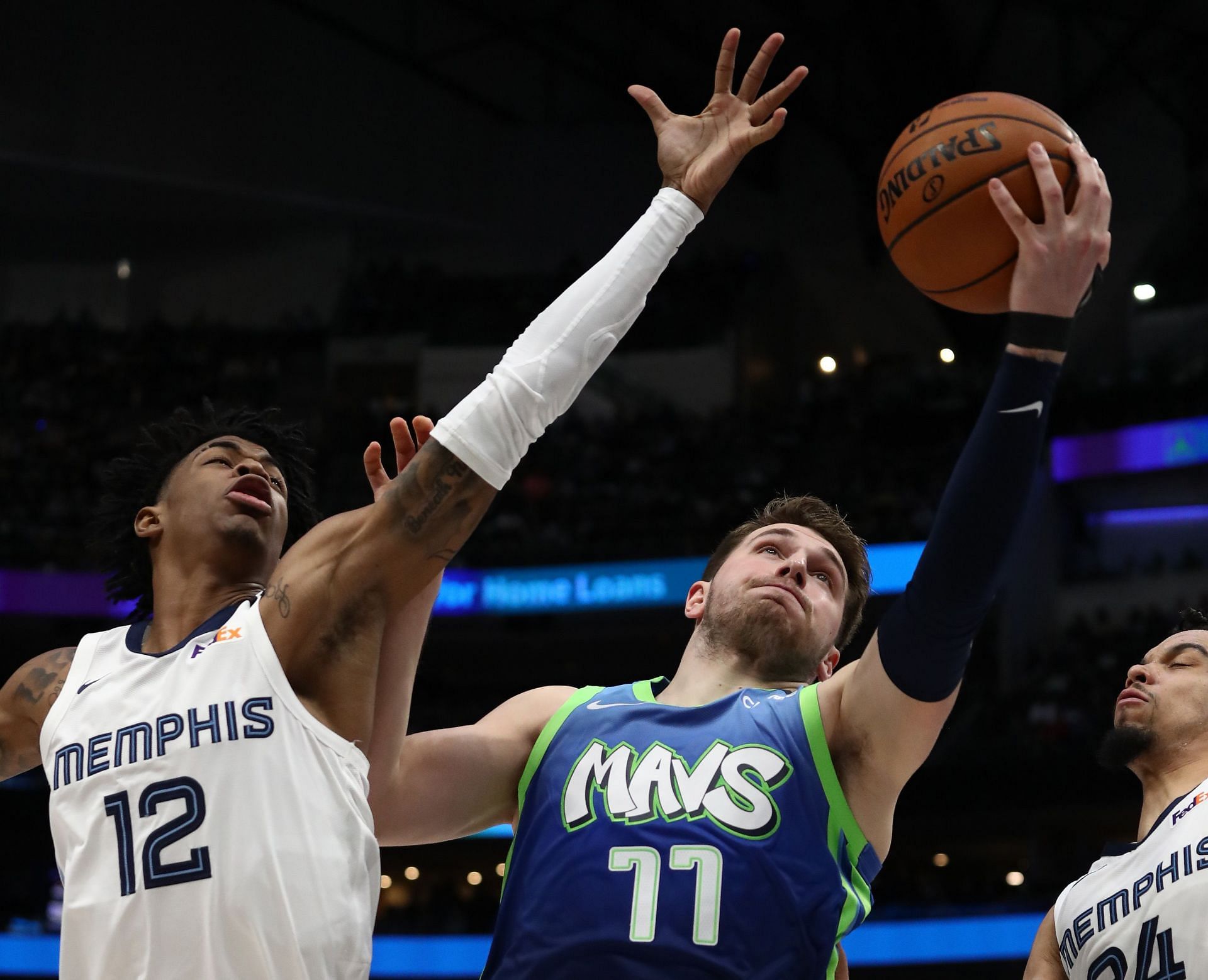 Ja Morant of the Memphis Grizzlies tries to block the shot of the Dallas Mavericks&#039; Luka Doncic.