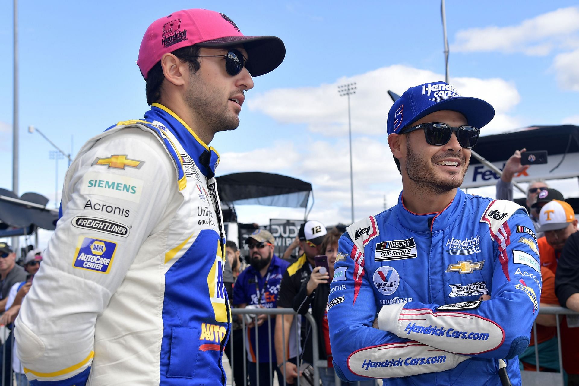 Chase Elliott (L) and Kyle Larson talk on the grid prior to the NASCAR Cup Series Xfinity 500 at Martinsville Speedway