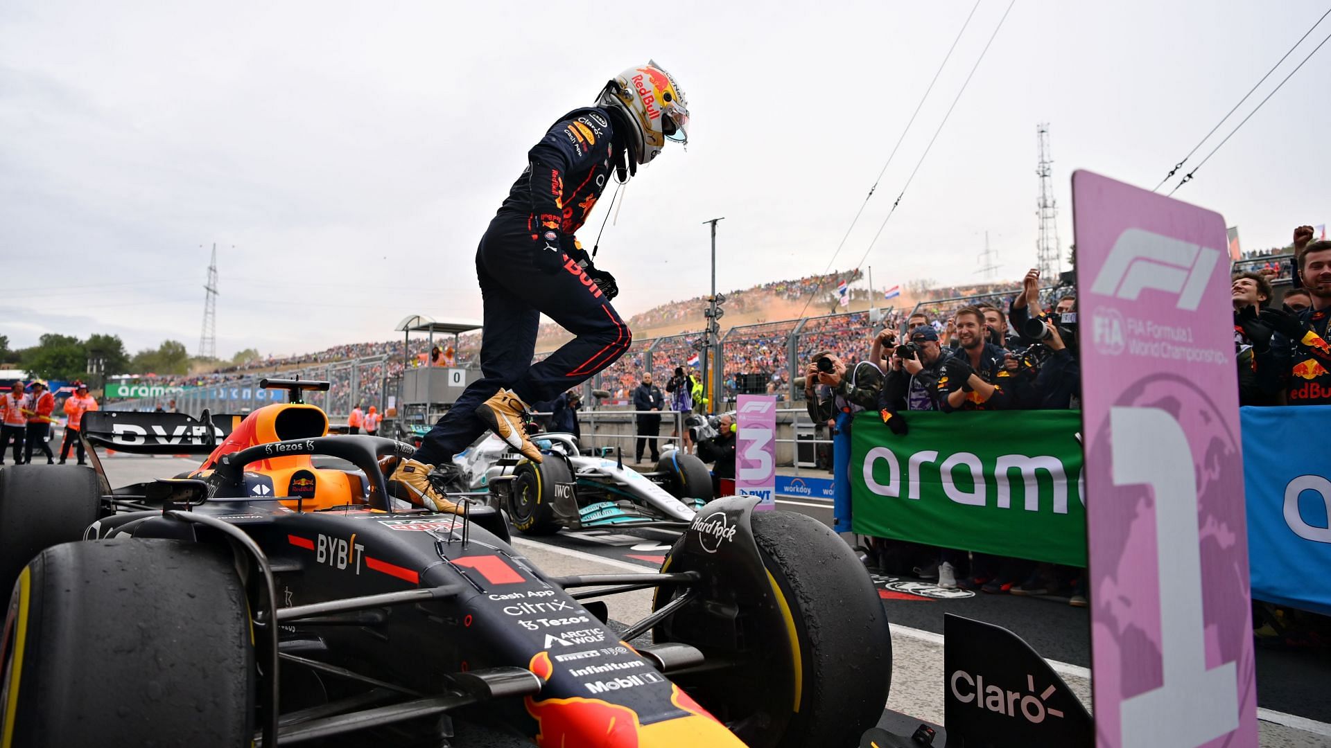 Max Verstappen emerges from the cockpit of his Red Bull RB18 after winning the 2022 F1 Hungarian GP. (Photo by Dan Mullan/Getty Images)