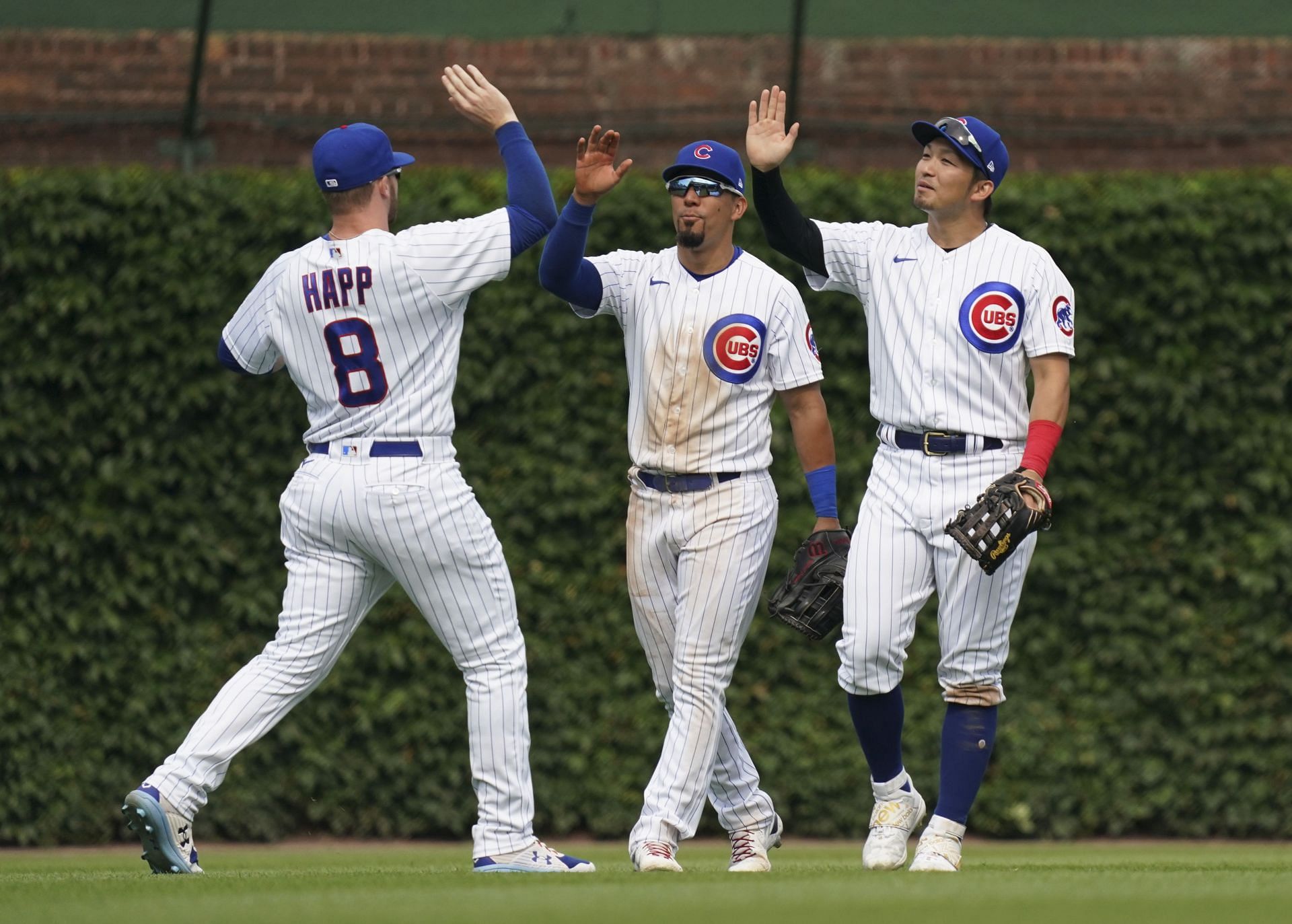Ian Happ (left), Christopher Morel (center) and Seiya Suzuki (right) celebrate a win against the Pittsburgh Pirates at Wrigley Field in Chicago, Illinois.