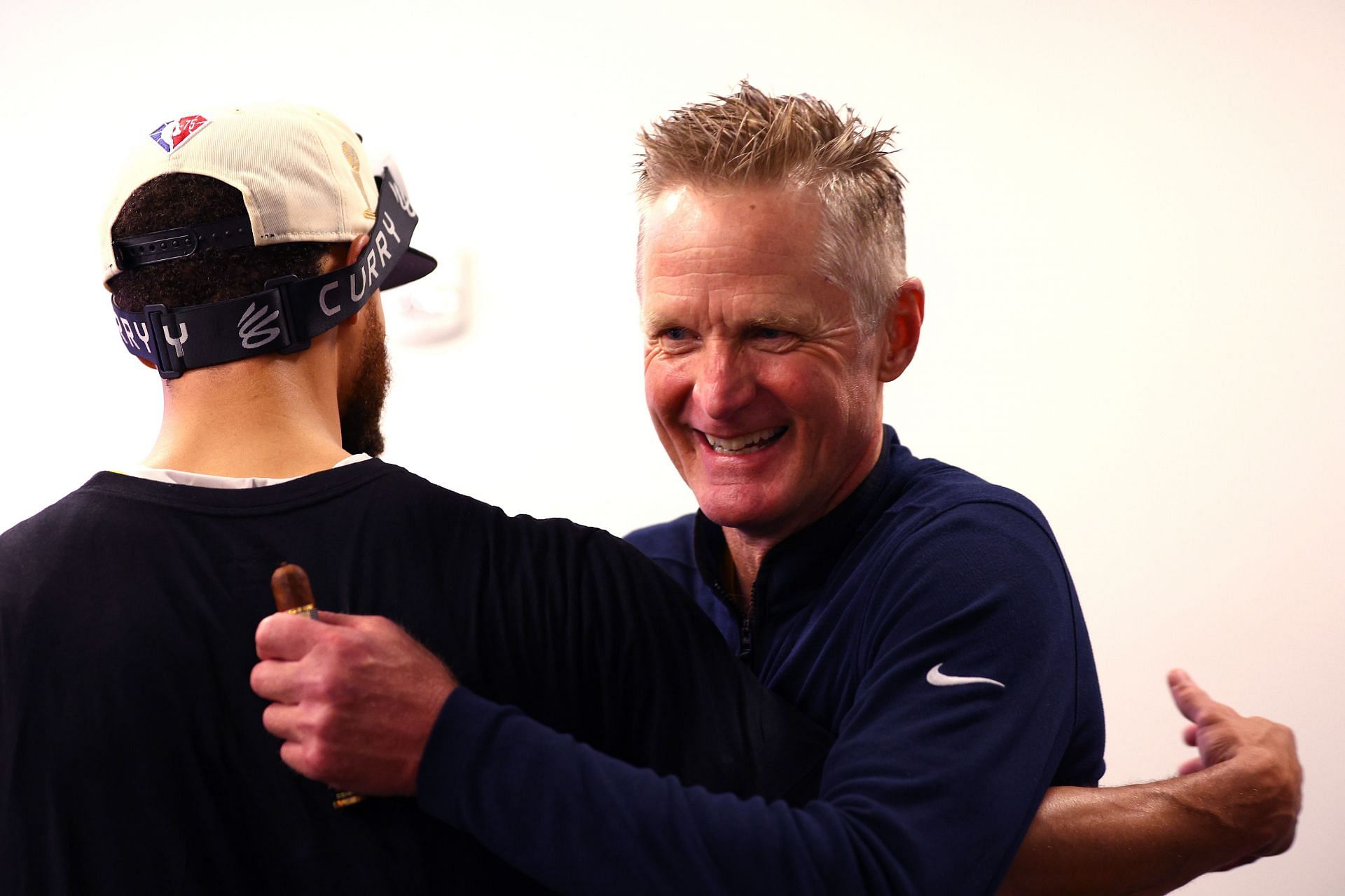 Steve Kerr celebrates with Steph Curry after winning the 2022 NBA Finals