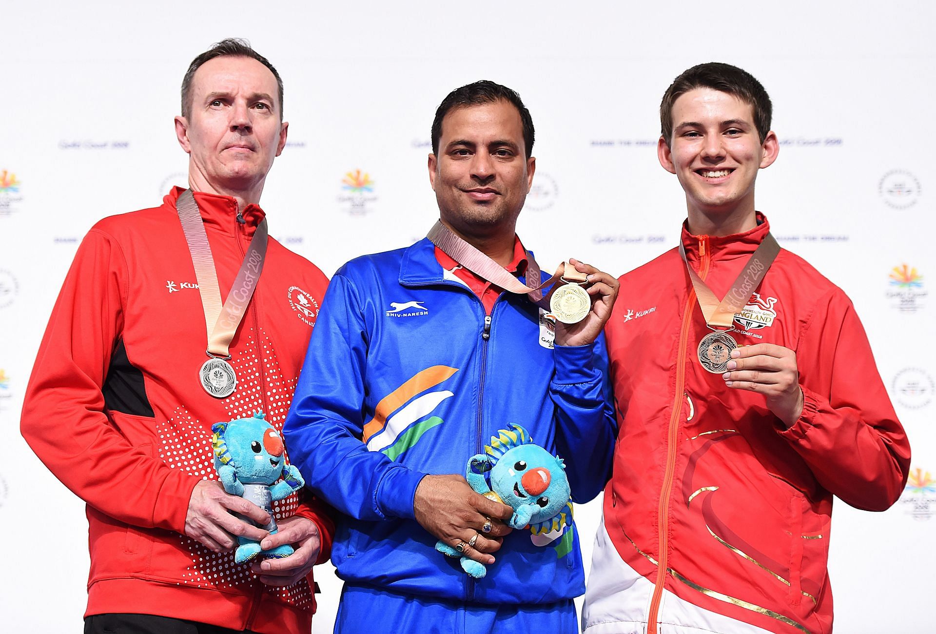 Silver medalist Grzegorz Sych (Canada), gold medalist Sanjeev Rajput (India), bronze medalist Dean Bale (England), Men&#039;s 50m Rifle 3P final at Gold Coast 2018 CWG. (Photo by Getty Images)