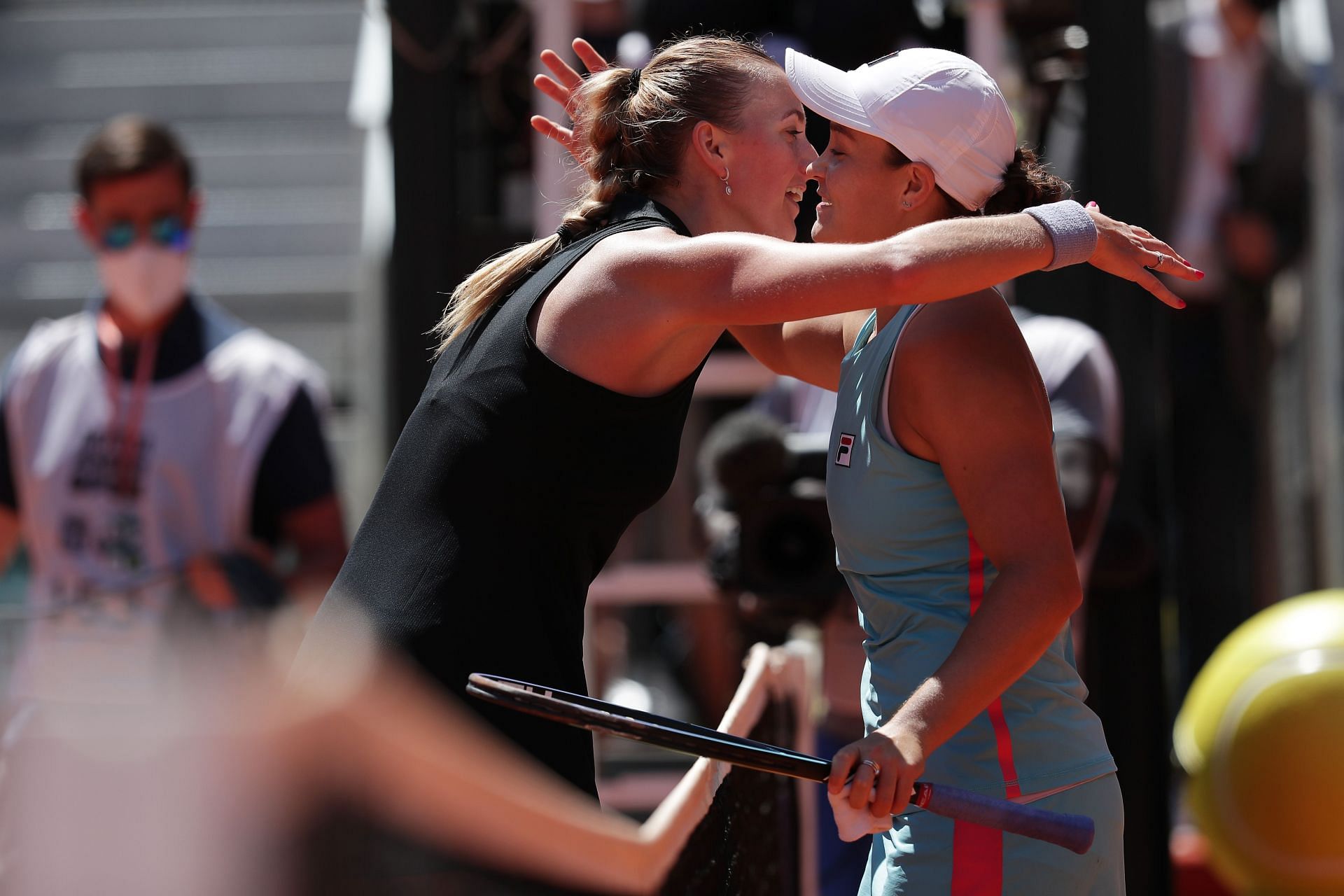 Petra Kvitova and Ashleigh Barty share a hug at the net after their quarterfinal match in Madrid last year.