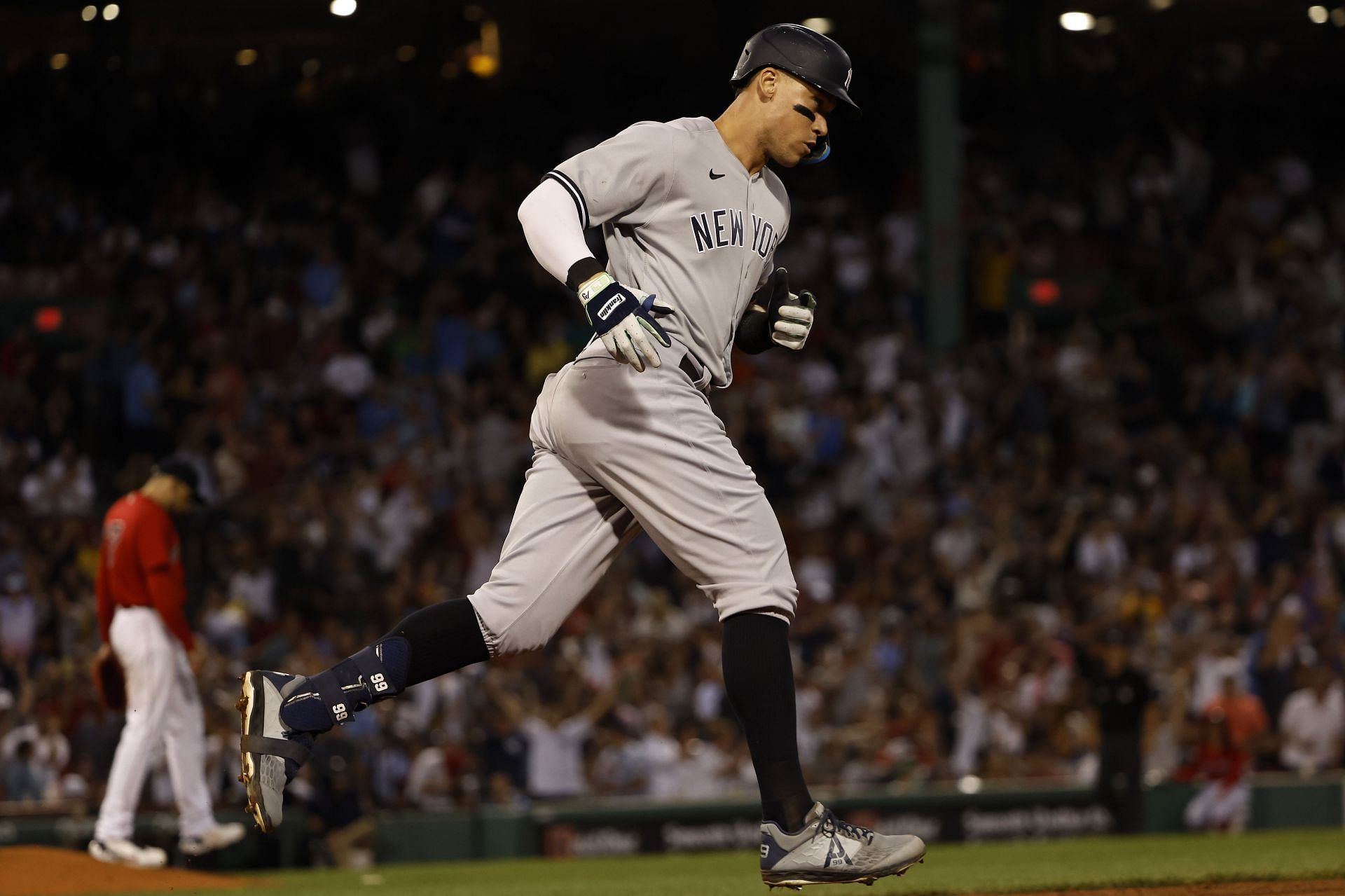 Aaron Judge #99 of the New York Yankees rounds the bases after his solo home run off of pitcher Nathan Eovaldi #17 of the Boston Red Sox during the third inning at Fenway Park on August 12, 2022
