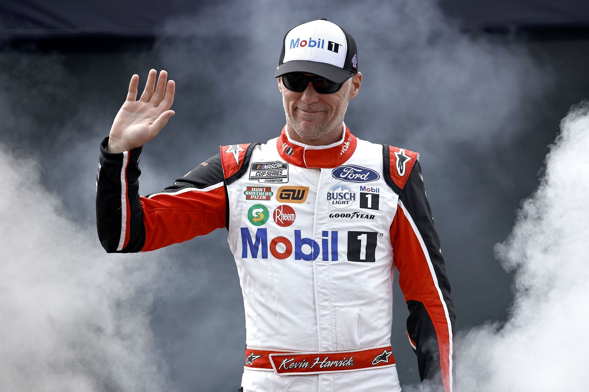 Kevin Harvick waves to fans as he walks onstage during driver intros before the NASCAR Cup Series Federated Auto Parts 400 at Richmond Raceway