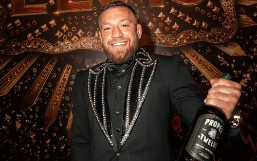 Conor McGregor holding a bottle of his Proper 12 whiskey (via @thenotoriousmma on Instagram)