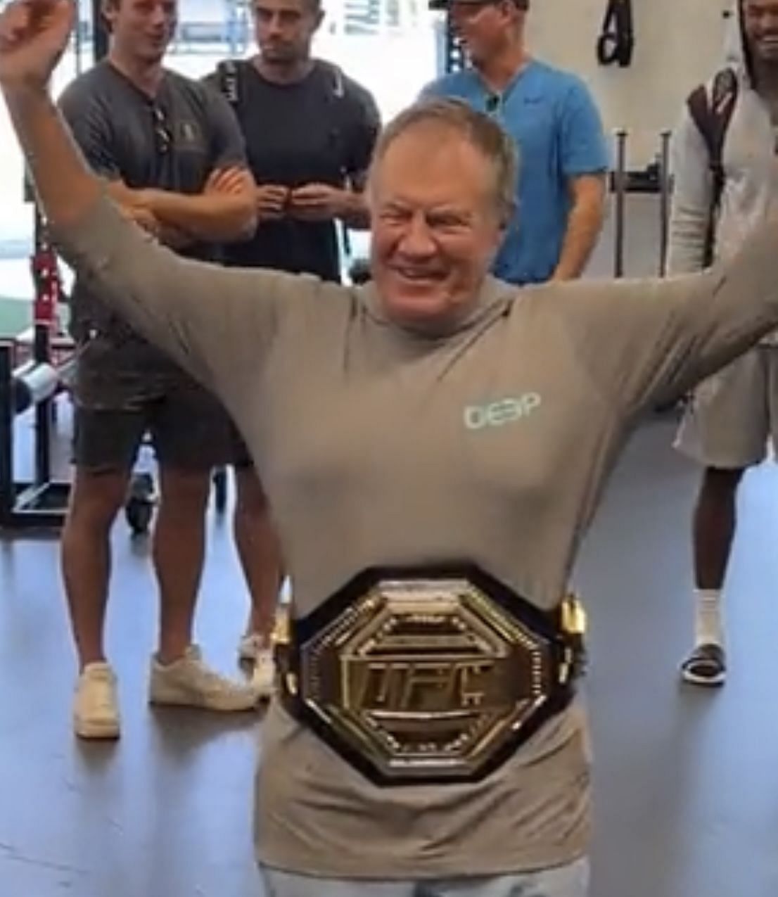 Bill Belichick proudly shows off his UFC title belt