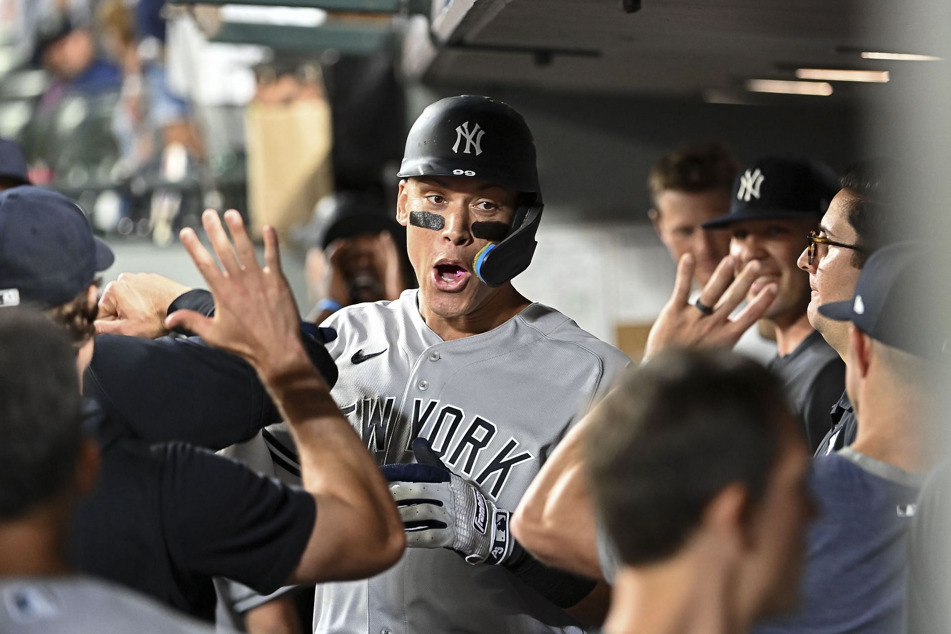 Aaron Judge of the New York Yankees celebrates with teammates after hitting a solo home run.