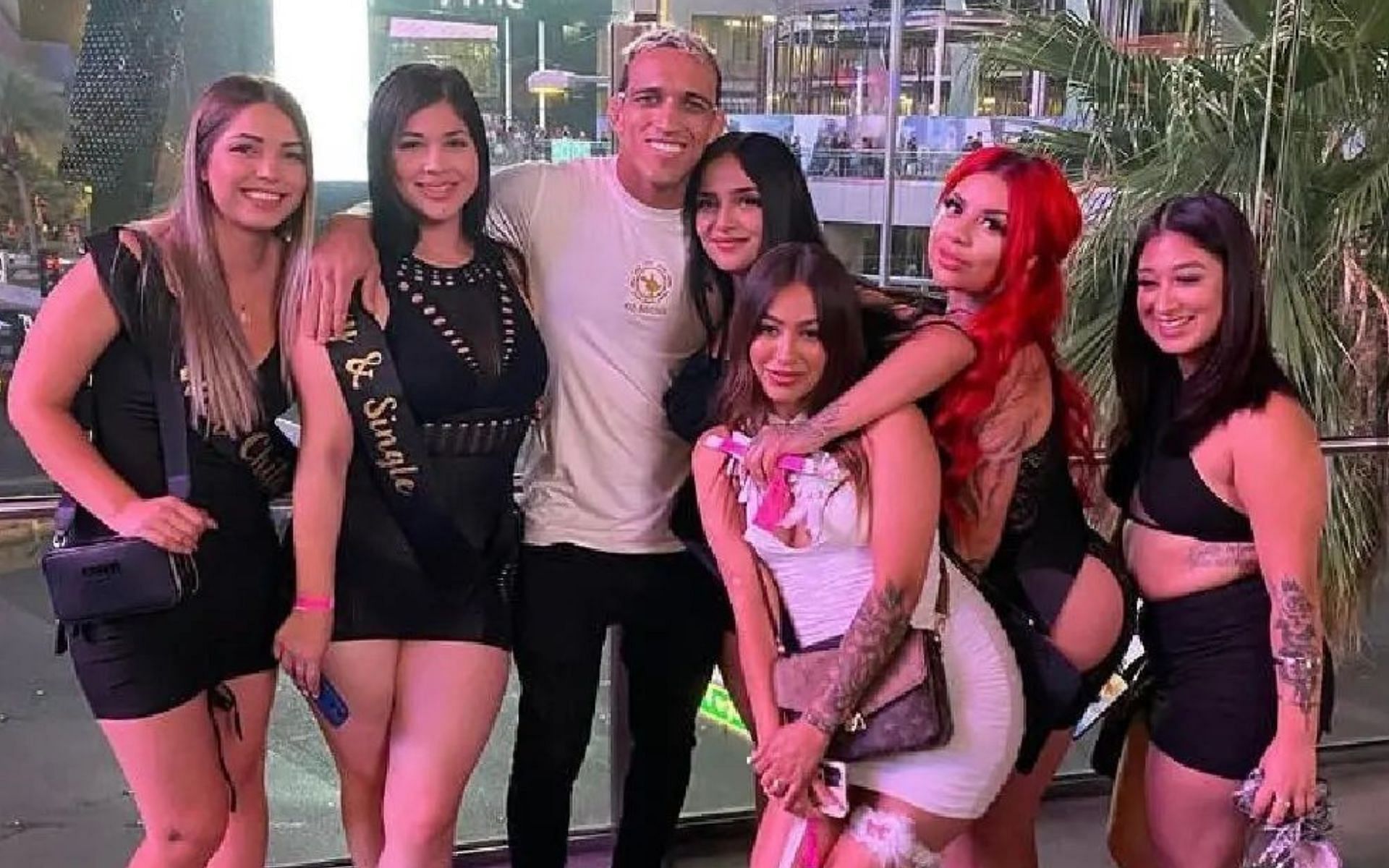 Fans hilariously react to Charles Oliveira posing for a picture with a  group of ladies