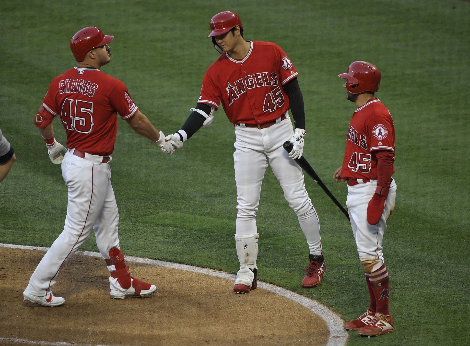 Mike Trout is congratulated by Shohei Ohtani for his two-run home run driving in David Fletcher.