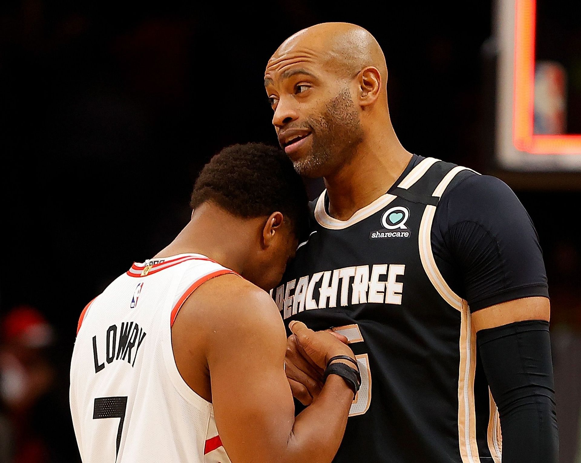 Kyle Lowry of the Toronto Raptors and Vince Carter of the Atlanta Hawks