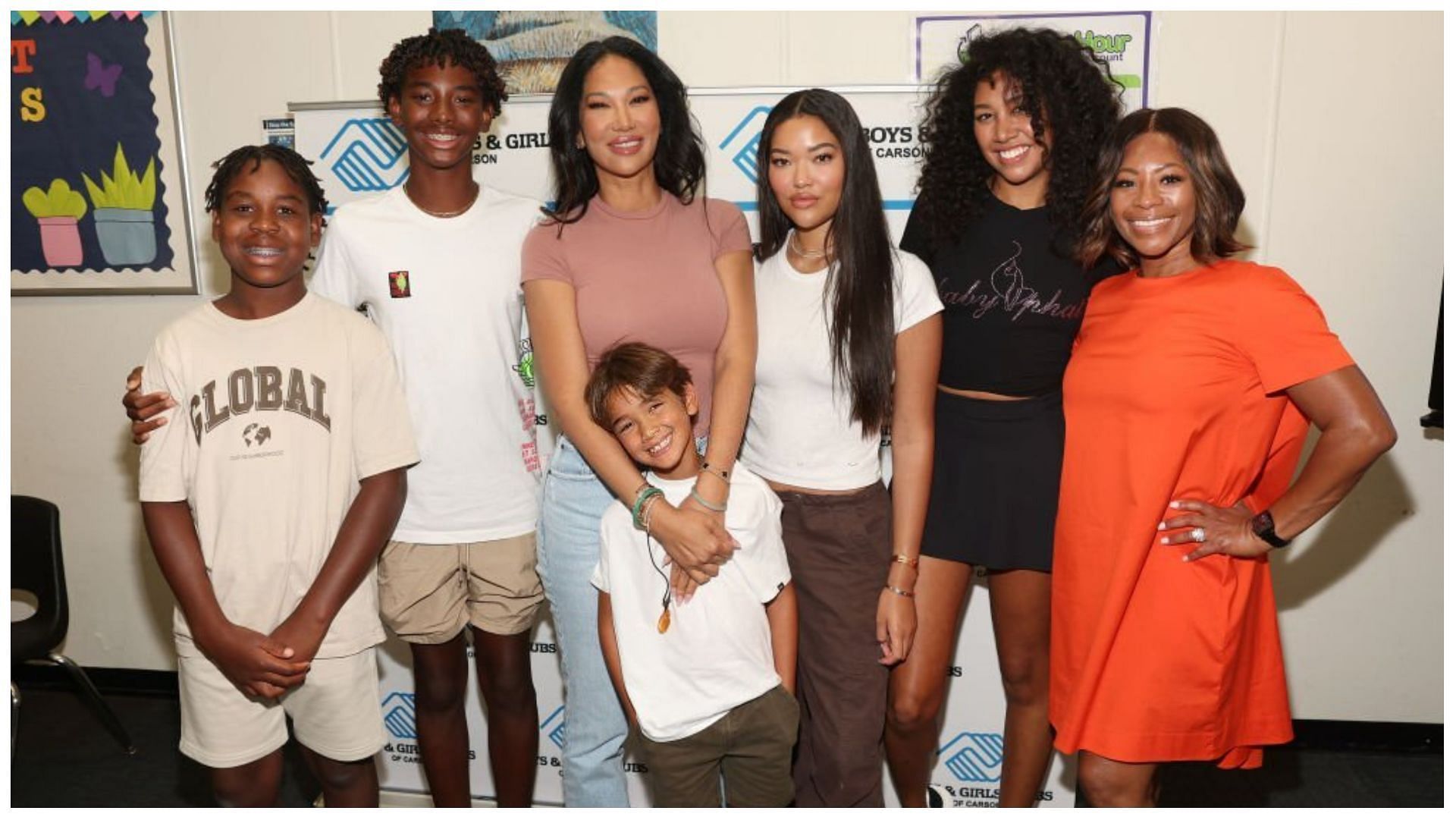 Kimora Lee Simmons with family and Bonita Price at a Back To School Giveaway (Image via Jesse Grant/Getty Images)