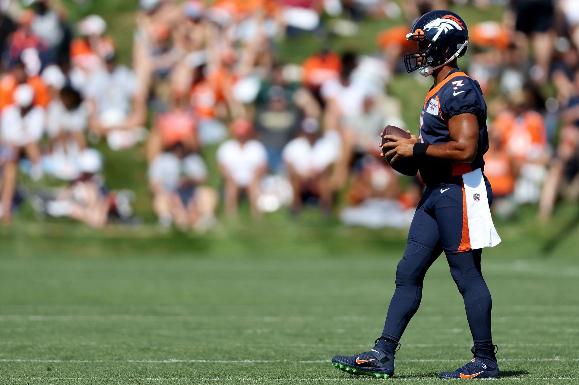 Denver Broncos quarterback Russel Wilson warms up during training camp.