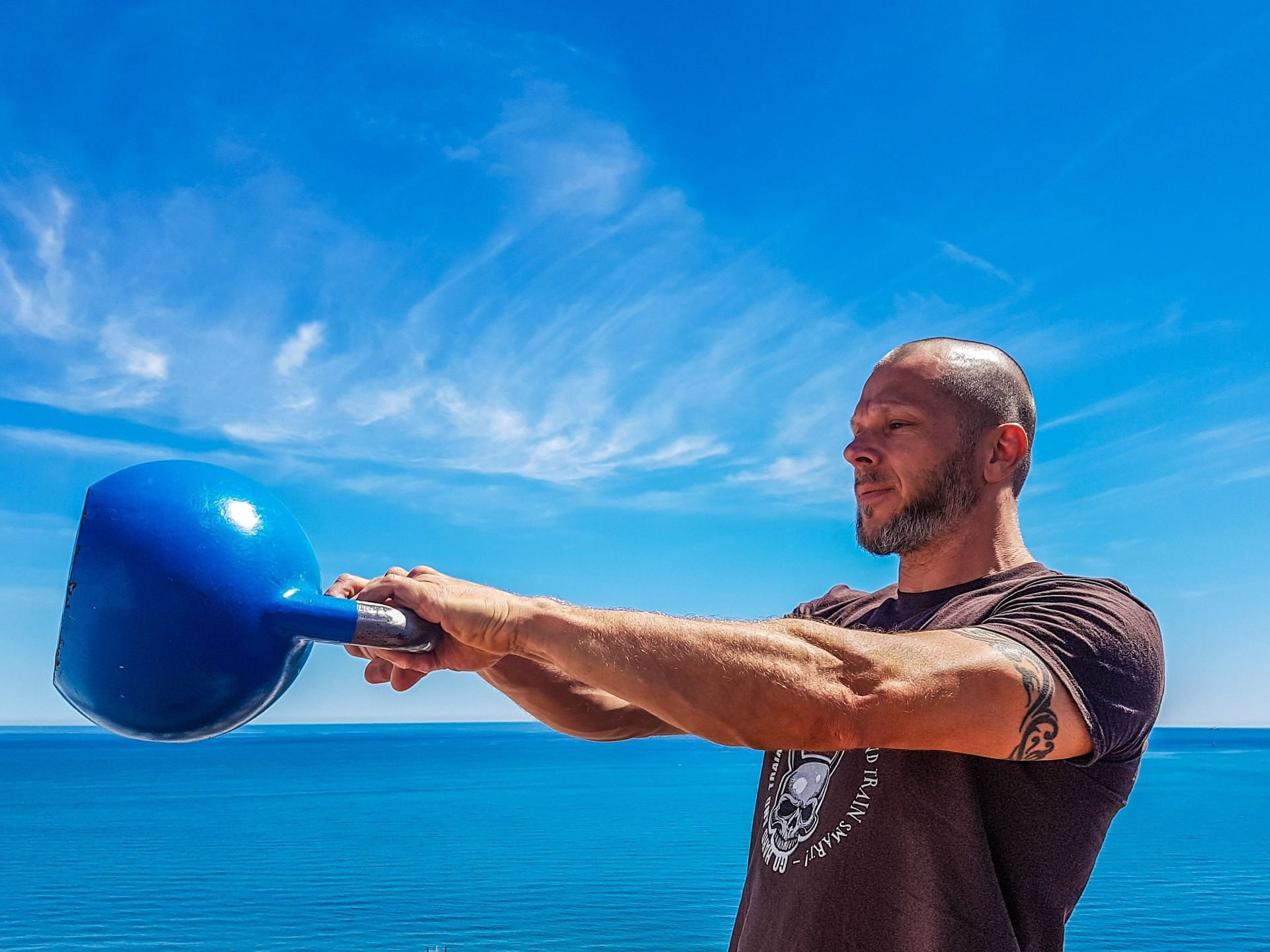 Kettlebell swing variants help strengthen the body and enhance performance. (Image via Unsplash/Taco Fleur)