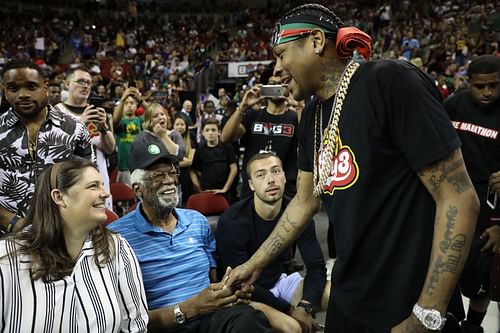 Bill Russell attends a basketball game with his fourth wife and shakes hands with Allen Iverson.