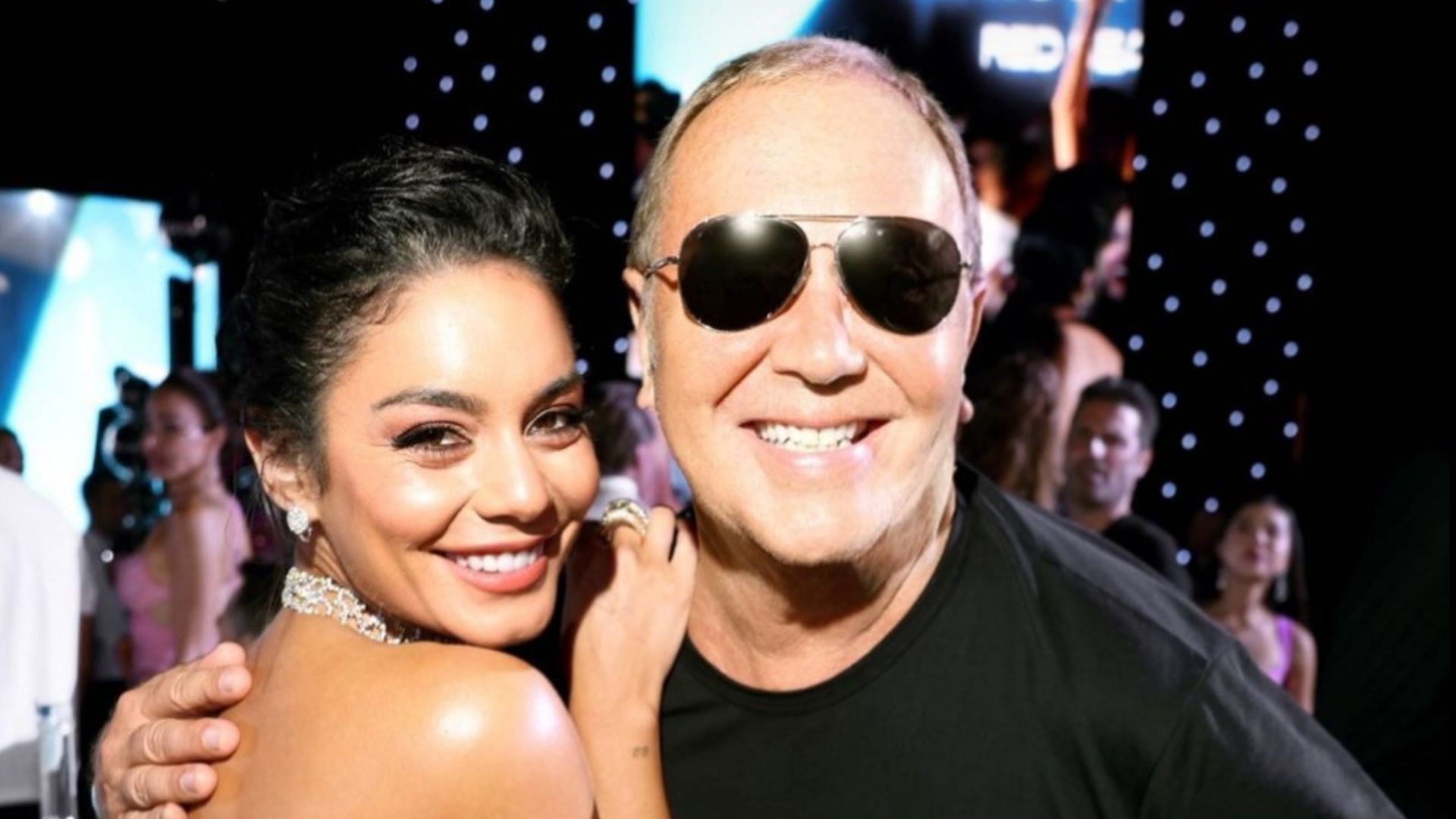 Hudgens poses with Michael Kors at the charity event.