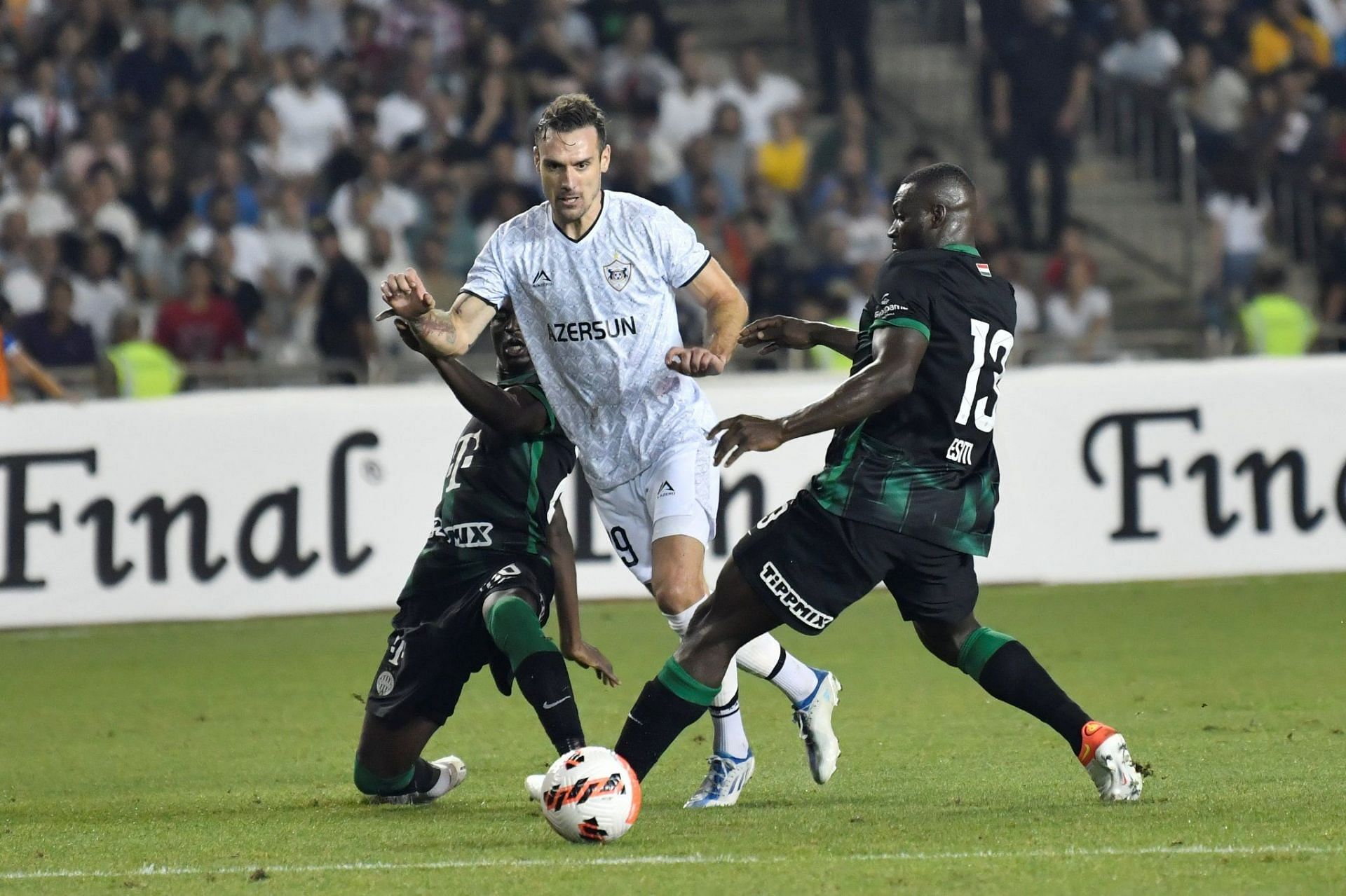 Mats Knoester of Ferencvarosi TC competes for the ball with