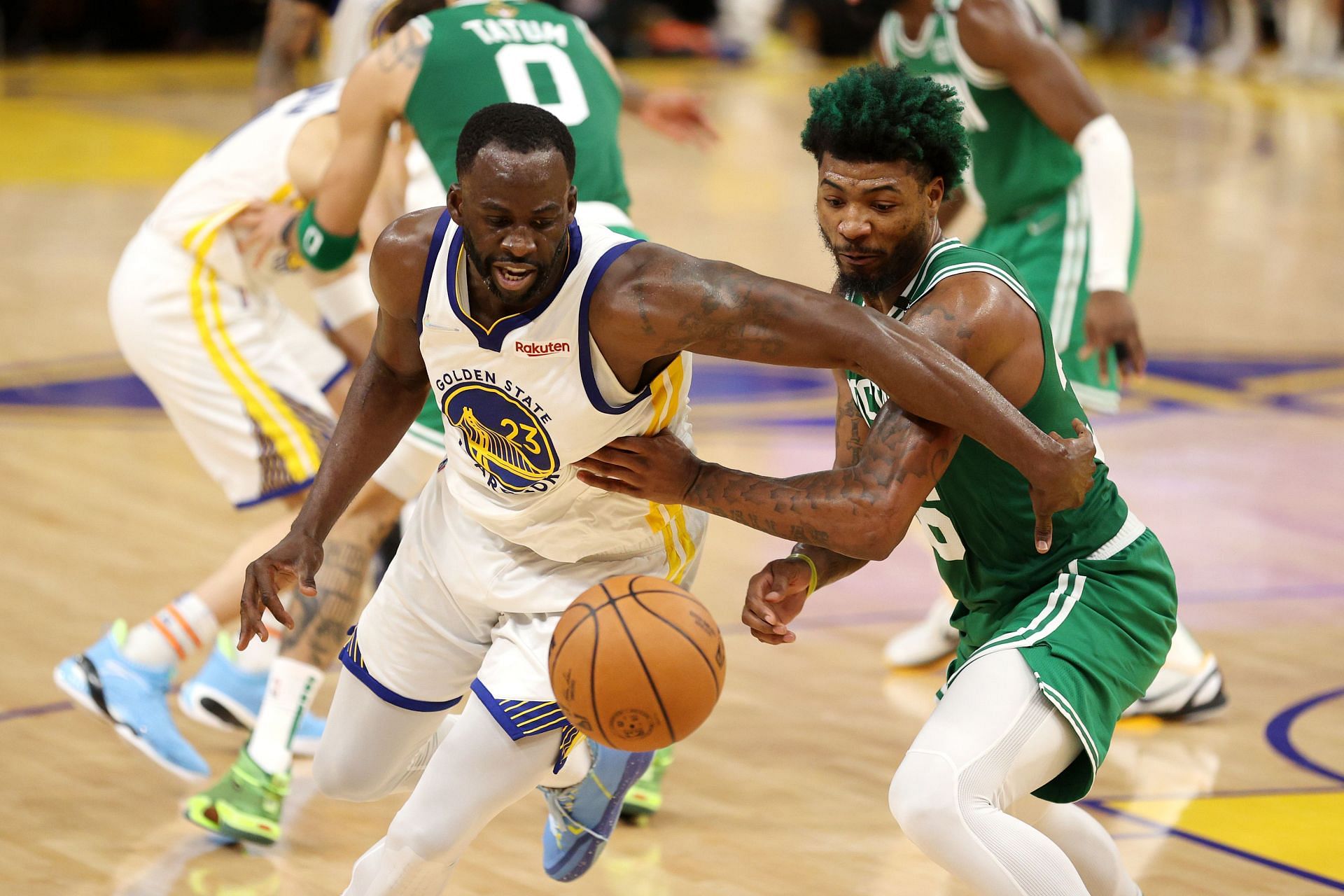 Draymond Green being guarded by Marcus Smart