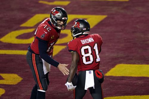 Tom Brady (left) alongside Antonio Brown celebrating a touchdown during the Tampa Bay Buccaneers' Wild Card Round against Washington Commanders