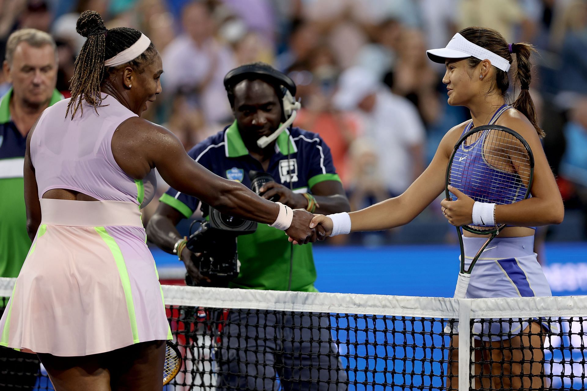 Serena Williams and Emma Raducanu shake hands following their opening-round contest at the 2022 Cincinnati Open