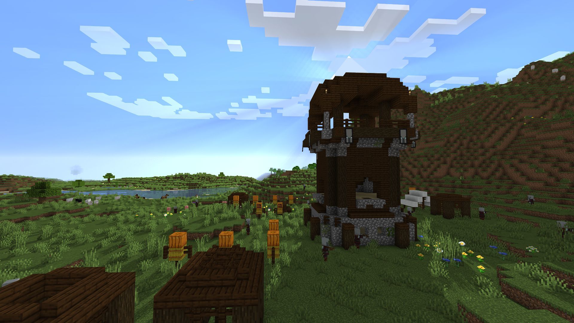 A pillager outpost at the base of a small mountain (Image via Minecraft)