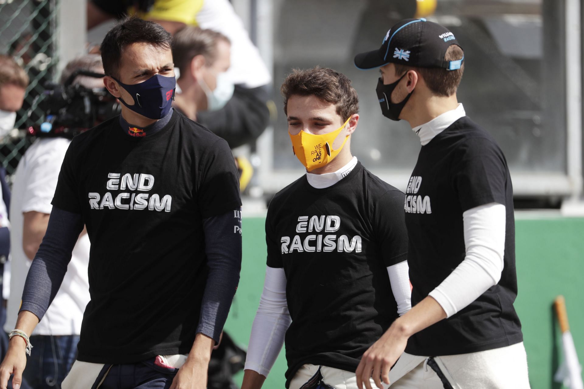 (L to R) Alexander Albon, Lando Norris, and George Russell talk on the grid before the F1 Grand Prix of Belgium at Circuit de Spa-Francorchamps on August 30, 2020, in Spa, Belgium (Photo by Stephanie Lecocq/Pool via Getty Images)