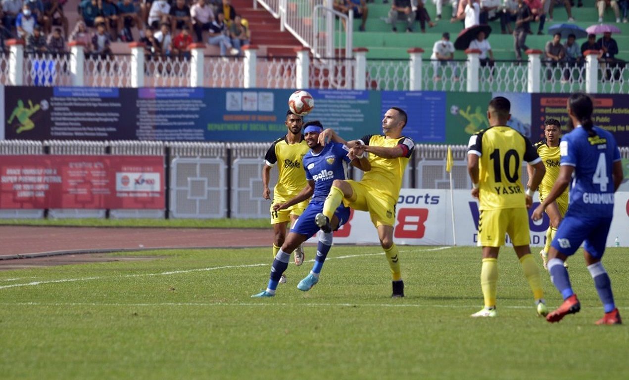 Hyderabad FC and Chennaiyin FC players tussling for the ball.
