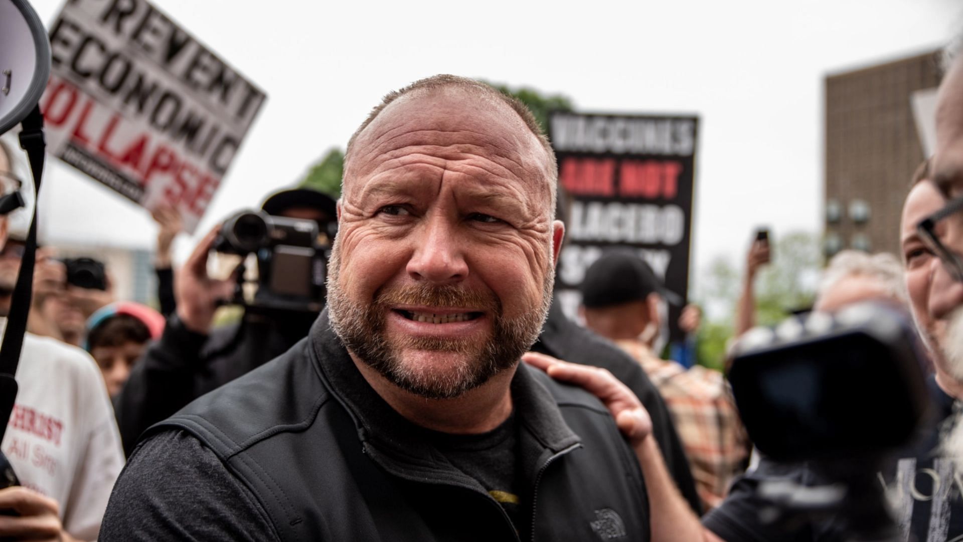 Alex Jones claimed that the 2012 Sandy Hook school shooting was staged by the government as a cover for gun control. (Image via Sergio Flores/Getty)