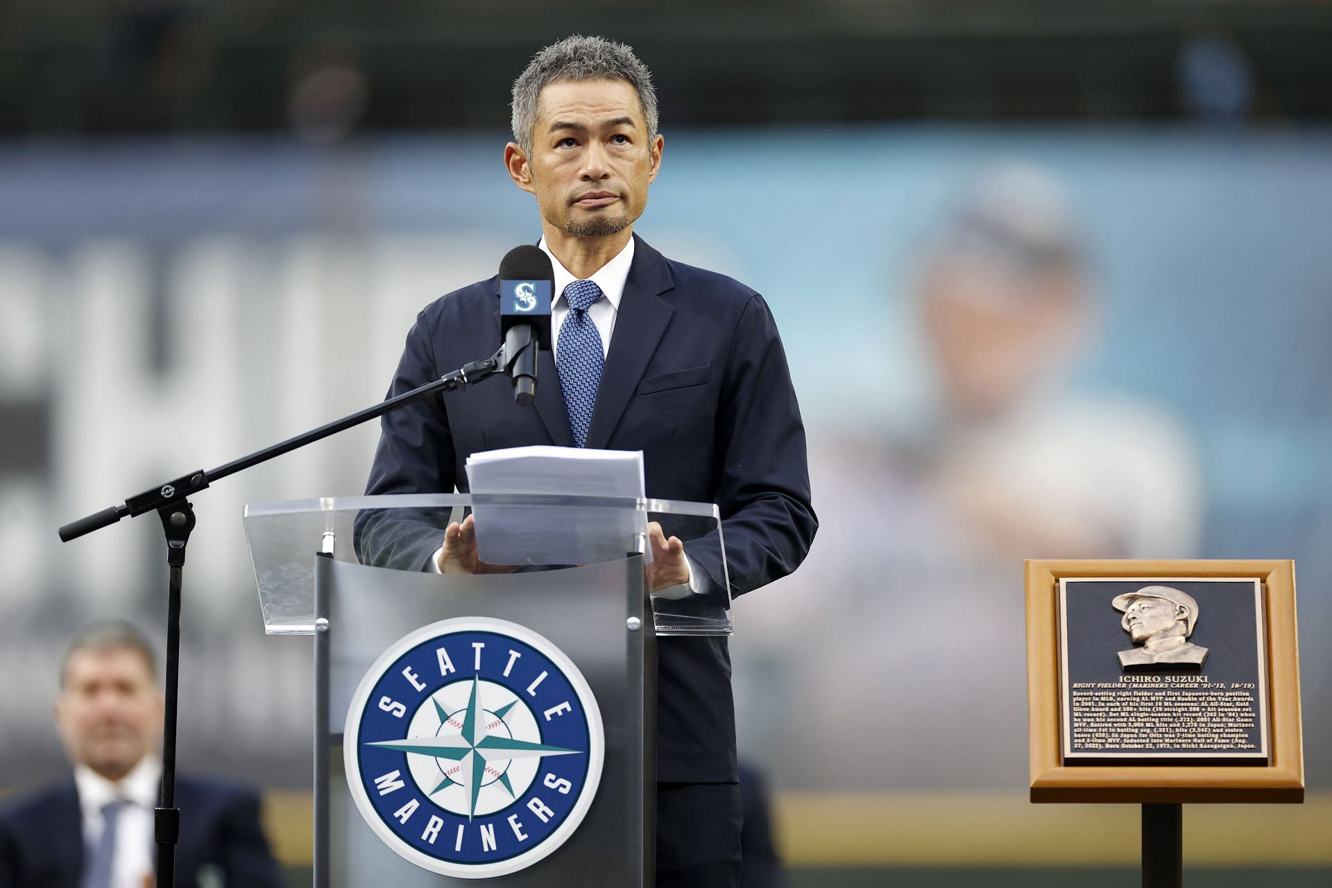 Seattle Mariners' Ichiro Suzuki, of Japan, (C), is met at home