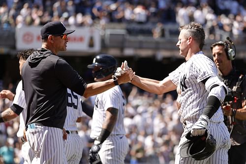 Manager Aaron Boone high-fives Josh Donaldson after his walk-off sacrifice fly against the Detroit Tigers.