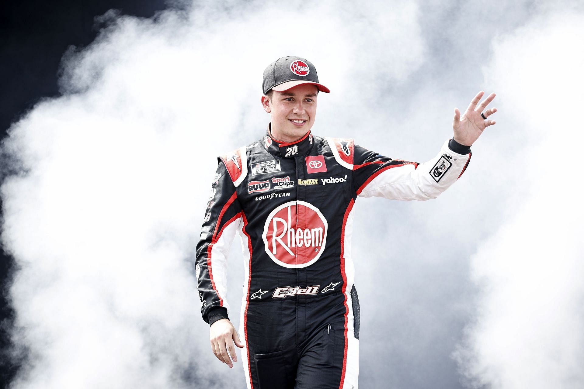 Christopher Bell waves to fans as he walks onstage during driver intros prior to the NASCAR Cup Series Federated Auto Parts 400 at Richmond Raceway