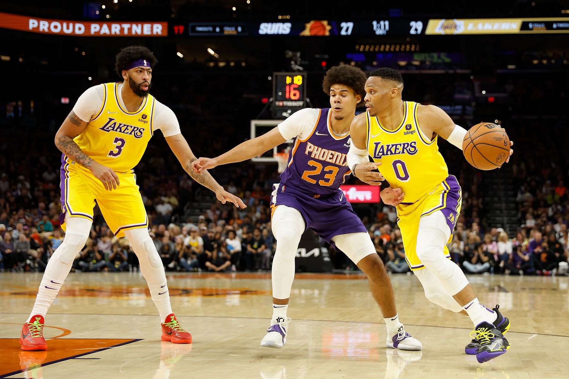 Russell Westbrook of the Los Angeles Lakers handles the ball against Cameron Johnson of the Phoenix Suns