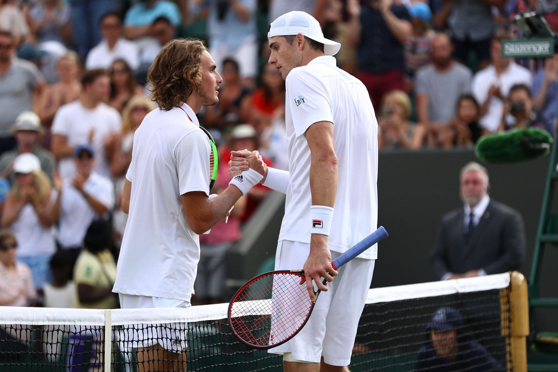 Stefanos Tsitsipas (L) and John Isner