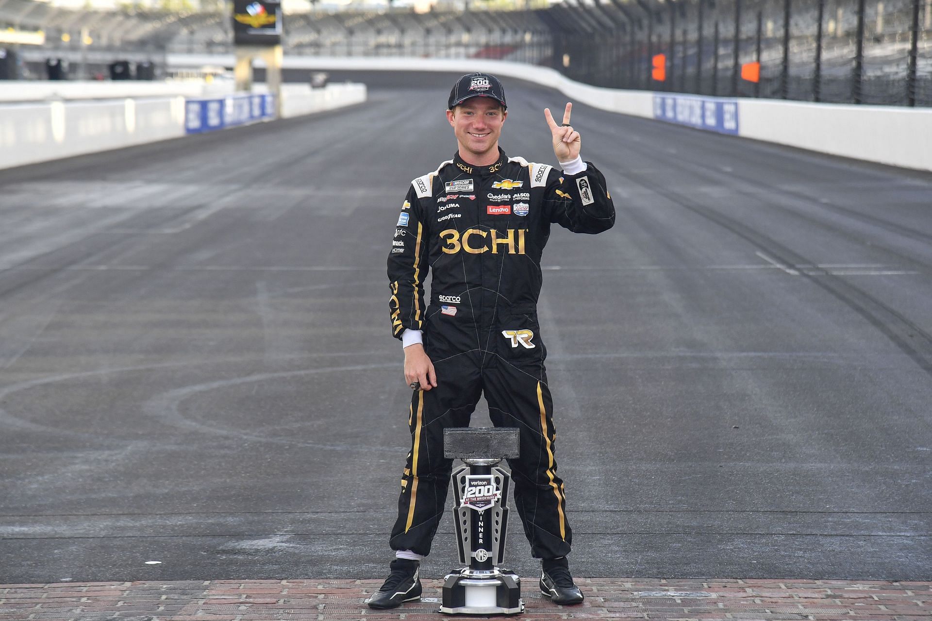 Tyler Reddick poses at the yard of bricks after winning the NASCAR Cup Series Verizon 200 at the Brickyard at Indianapolis Motor Speedway