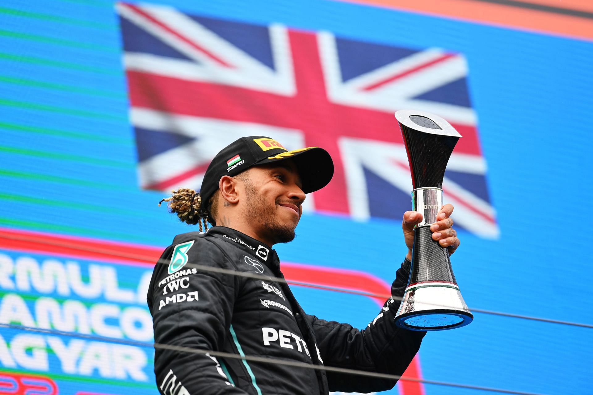 Mercedes driver Lewis Hamilton celebrates on the podium after his P2 finish at the 2022 F1 Hungarian GP (Photo by Dan Mullan/Getty Images)