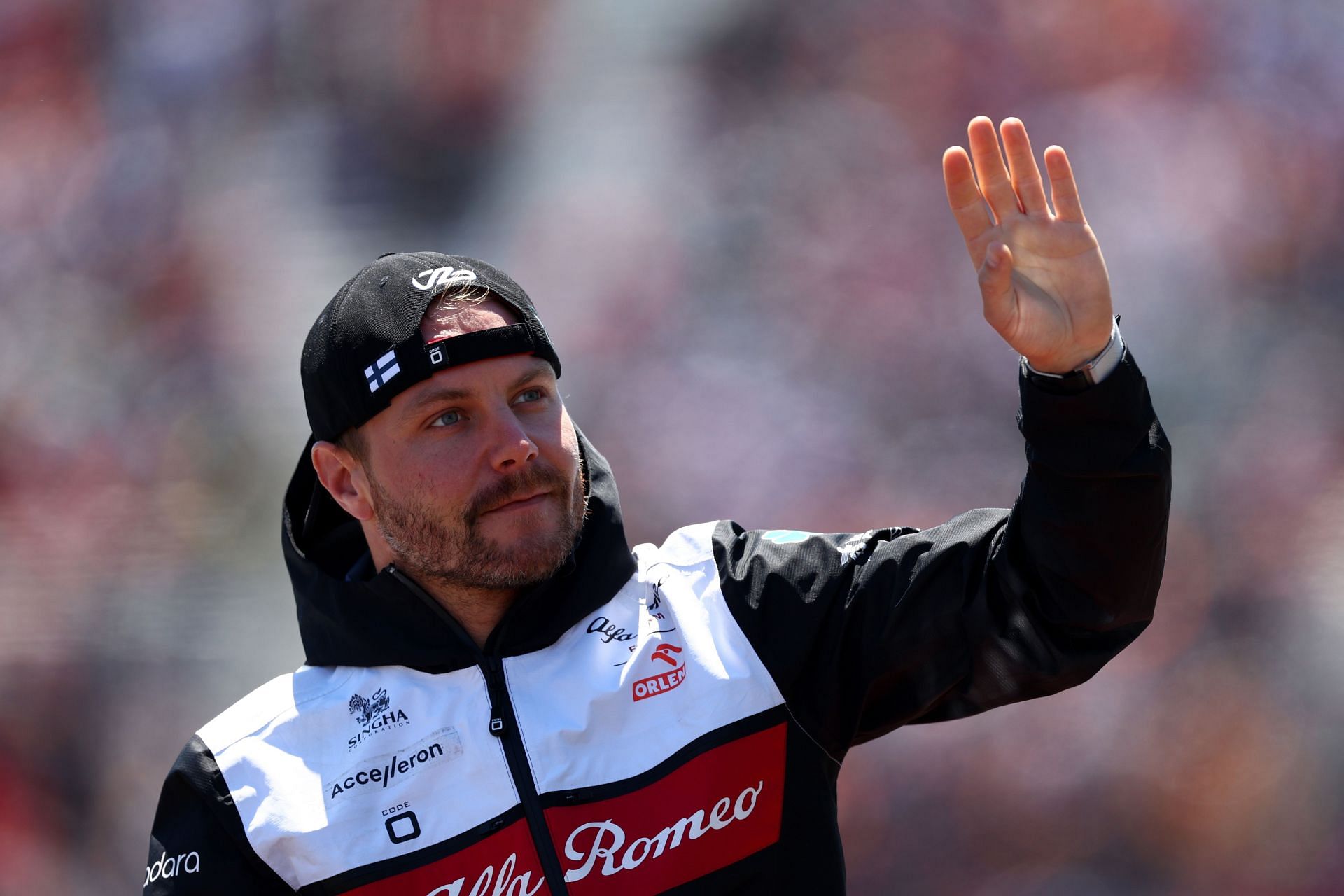 Alfa Romeo driver Valtteri Bottas waves to the crowd during the drivers parade ahead of the 2022 F1 Canadian GP (Photo by Clive Rose/Getty Images)